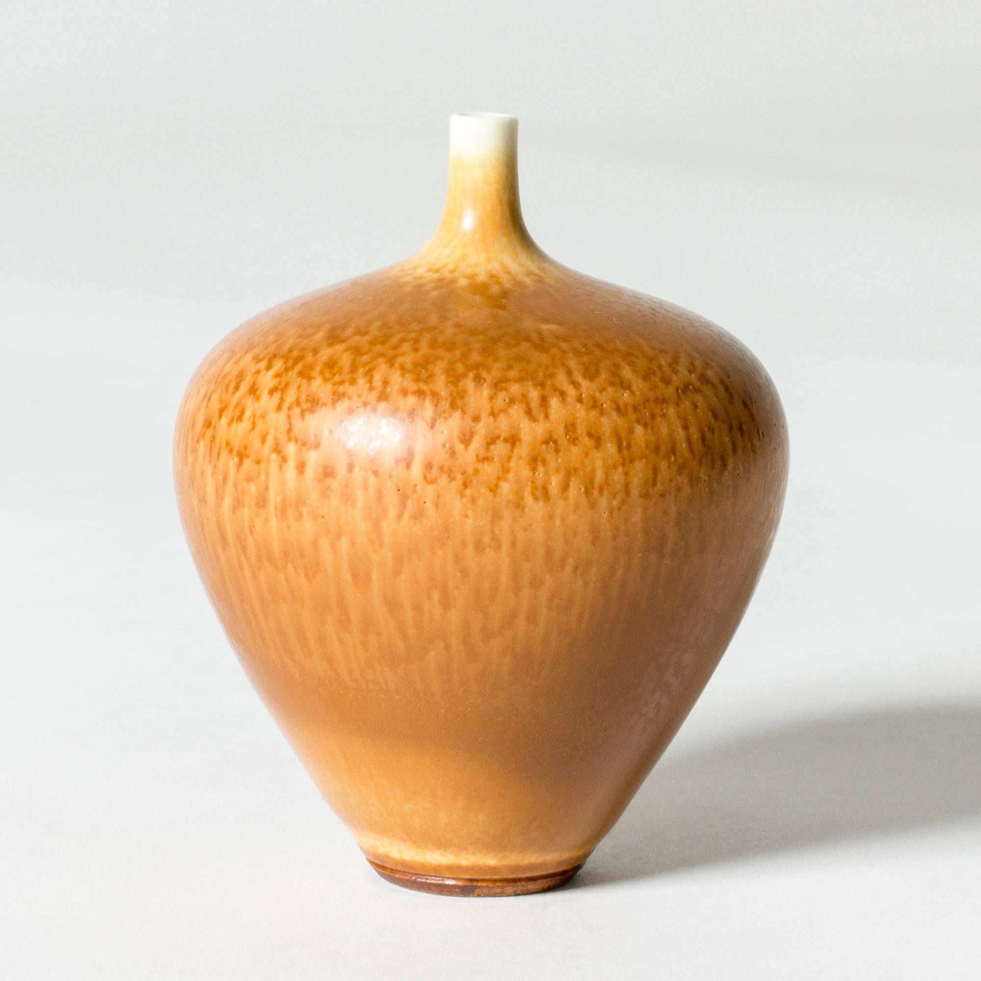 Lovely miniature stoneware vase by Berndt Friberg, in an ample apple form with a thin neck. Decorated with warm ochre hare’s fur glaze.

Berndt Friberg was a Swedish ceramicist, renowned for his stoneware vases and vessels for Gustavsberg. His pure,
