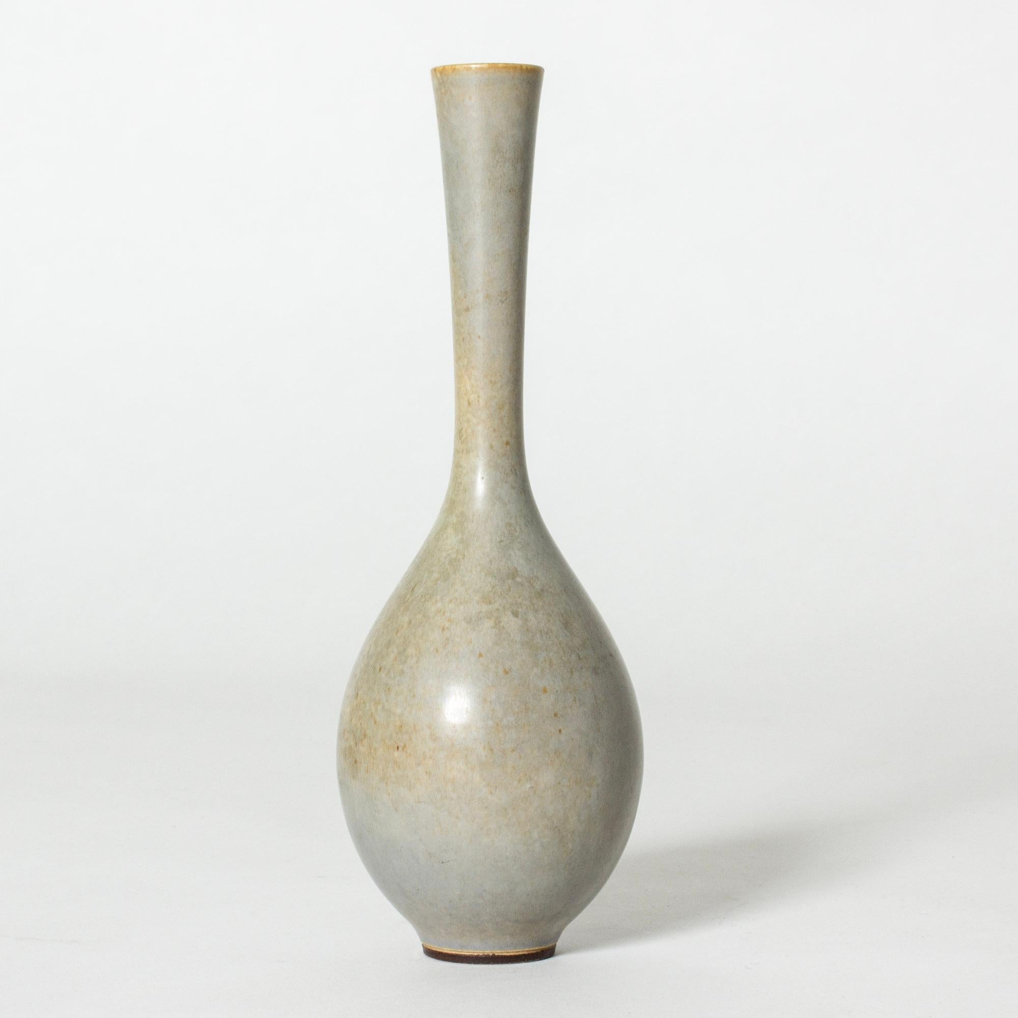 Lovely stoneware vase by Berndt Friberg, in a slender onion form with a long neck. Greyish blue glaze with yellow nuances.

Berndt Friberg was a Swedish ceramicist, renowned for his stoneware vases and vessels for Gustavsberg. His pure, composed