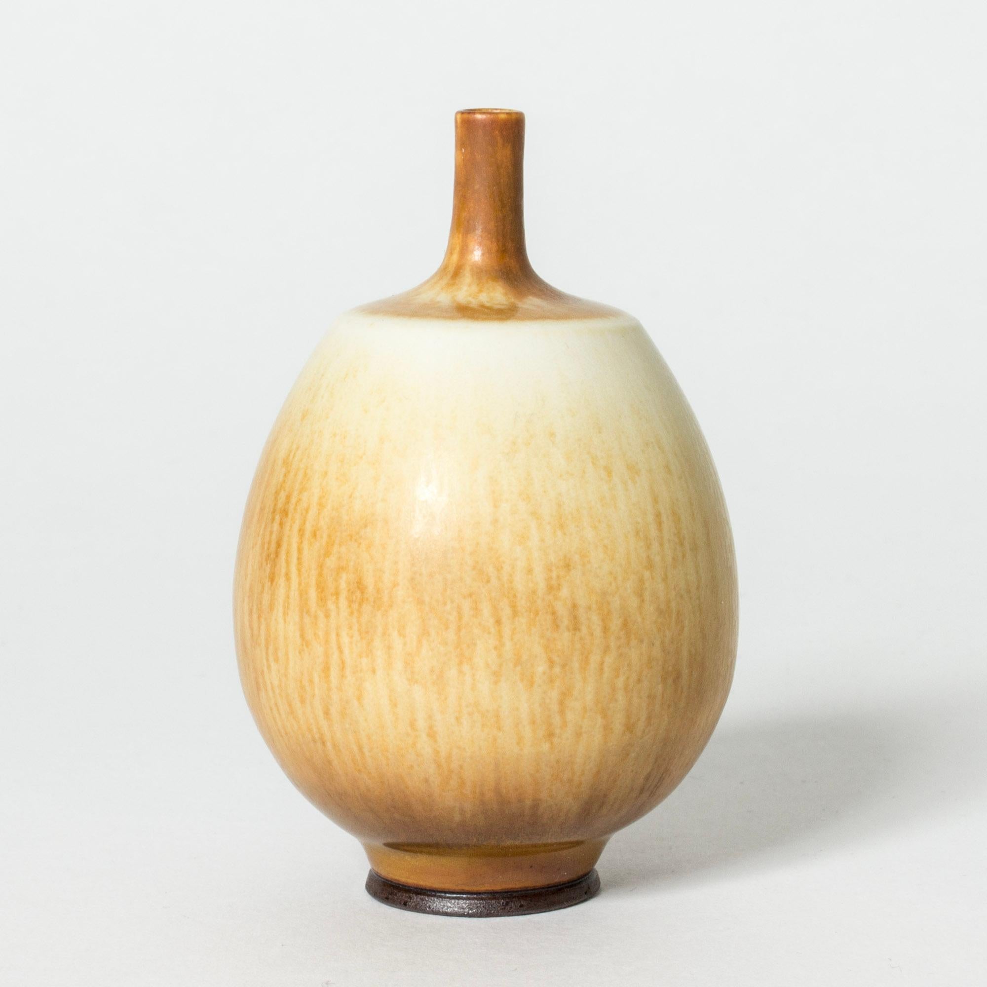 Lovely miniature stoneware vase by Berndt Friberg, in a plump form with a tiny neck. Cream and ochre hare’s fur glaze in a varying pattern over the body.

Berndt Friberg was a Swedish ceramicist, renowned for his stoneware vases and vessels for