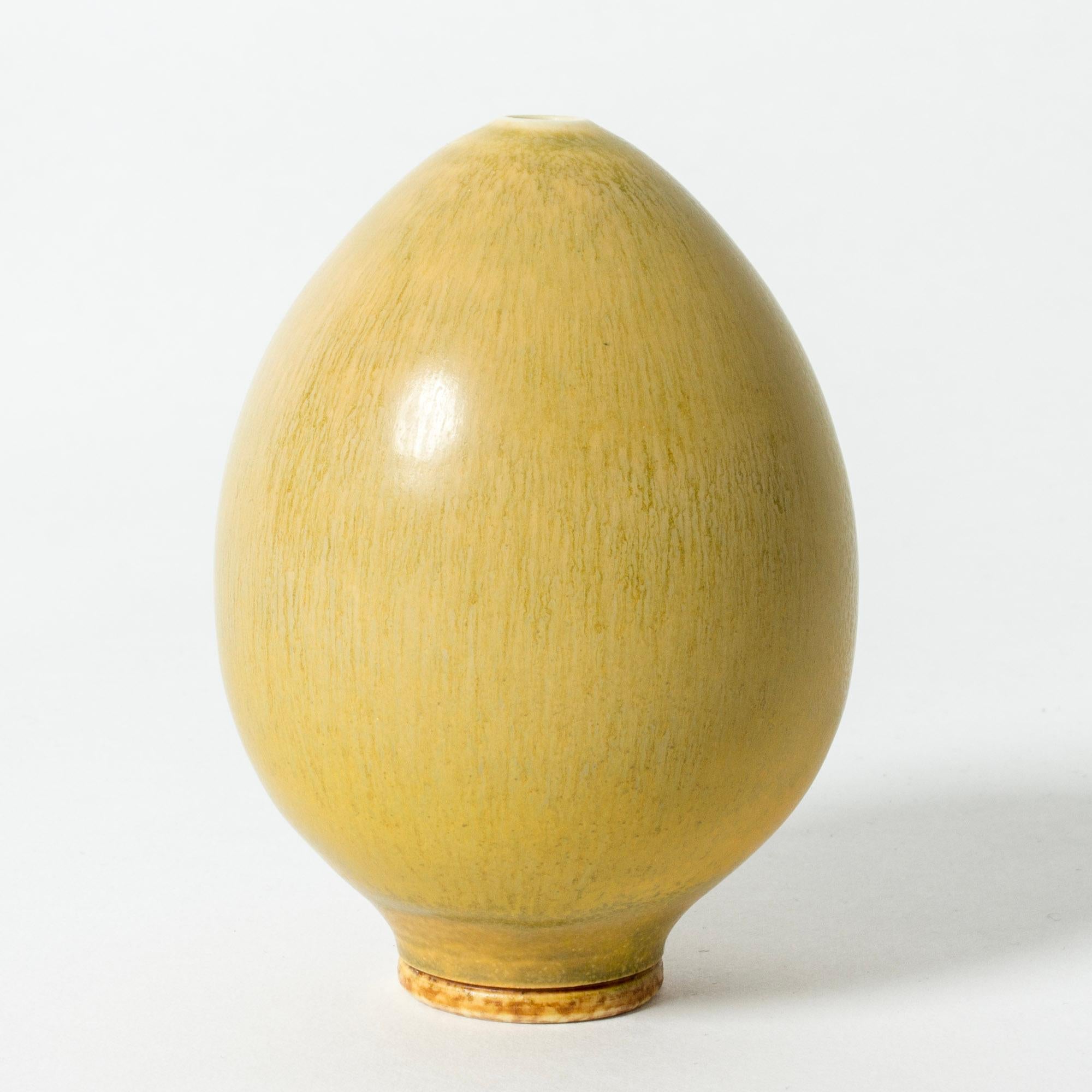 Lovely, small stoneware vase by Berndt Friberg, in the form of a slim egg. Delicately made, with yellow hare’s fur glaze.

Berndt Friberg was a Swedish ceramicist, renowned for his stoneware vases and vessels for Gustavsberg. His pure, composed