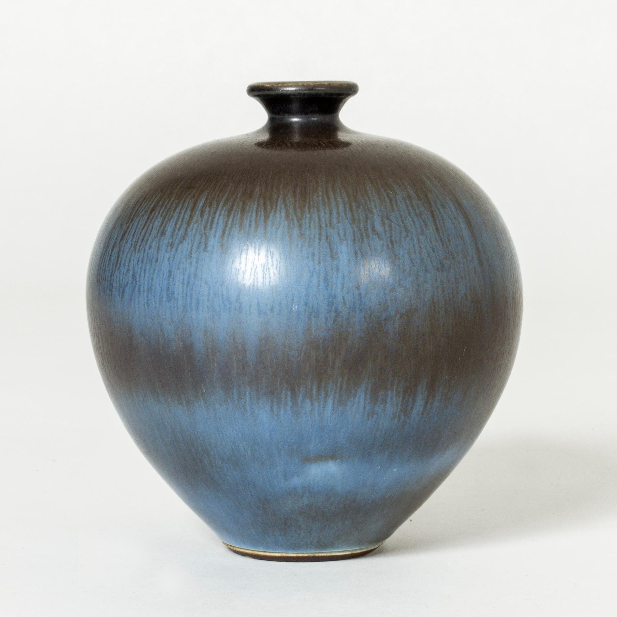 Beautiful stoneware vase by Berndt Friberg, in a plump form. Striking hare’s fur glaze in blue and dark brown blending into each other in wide stripes across the body.

Berndt Friberg was a Swedish ceramicist, renowned for his stoneware vases and