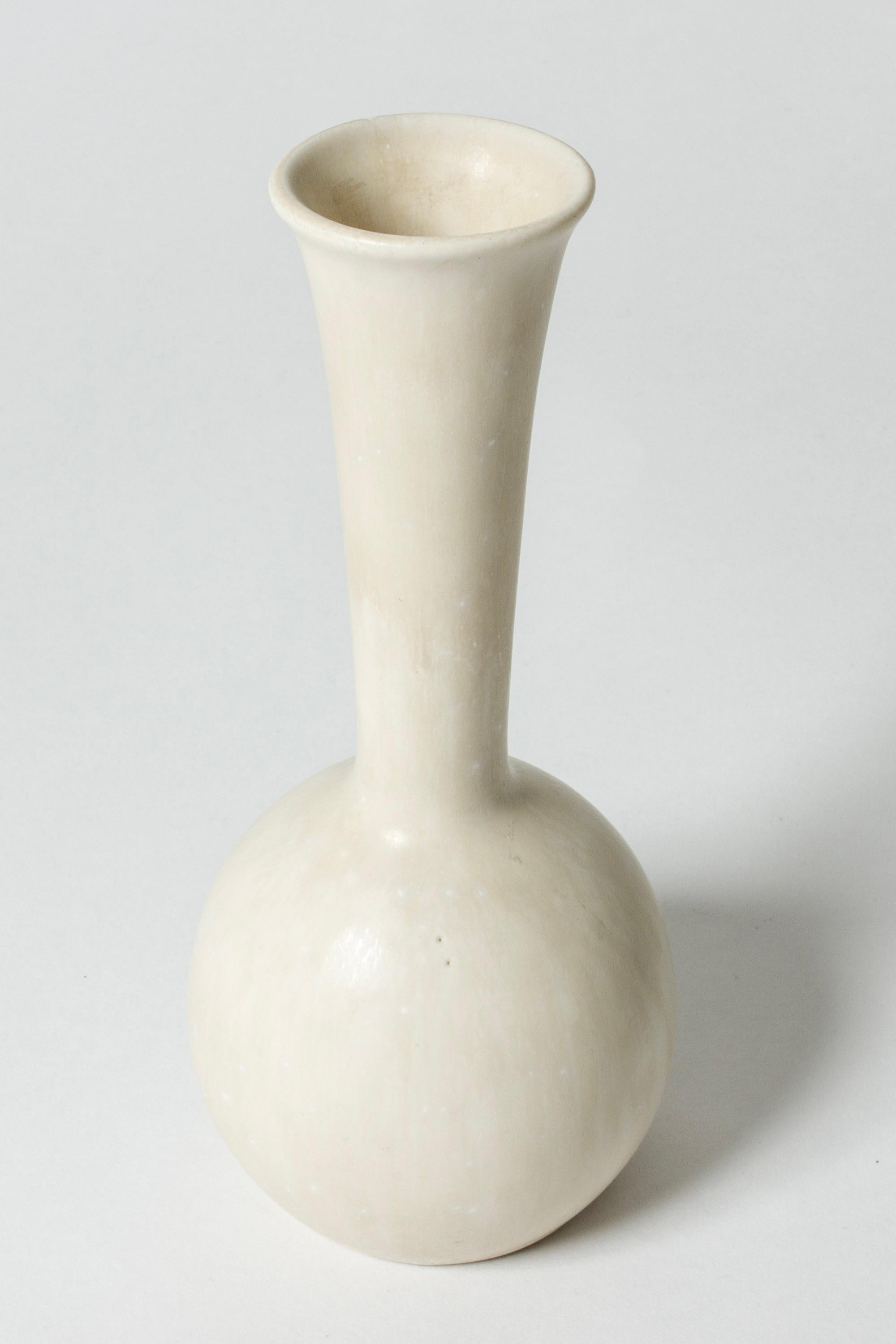 Lovely stoneware vase by Gunnar Nylund, in an onion form. Glazed eggshell white.

Gunnar Nylund was one of the most influential ceramicists and designers of the Swedish mid-century period. He was Rörstrand’s creative leader from 1931 until 1949