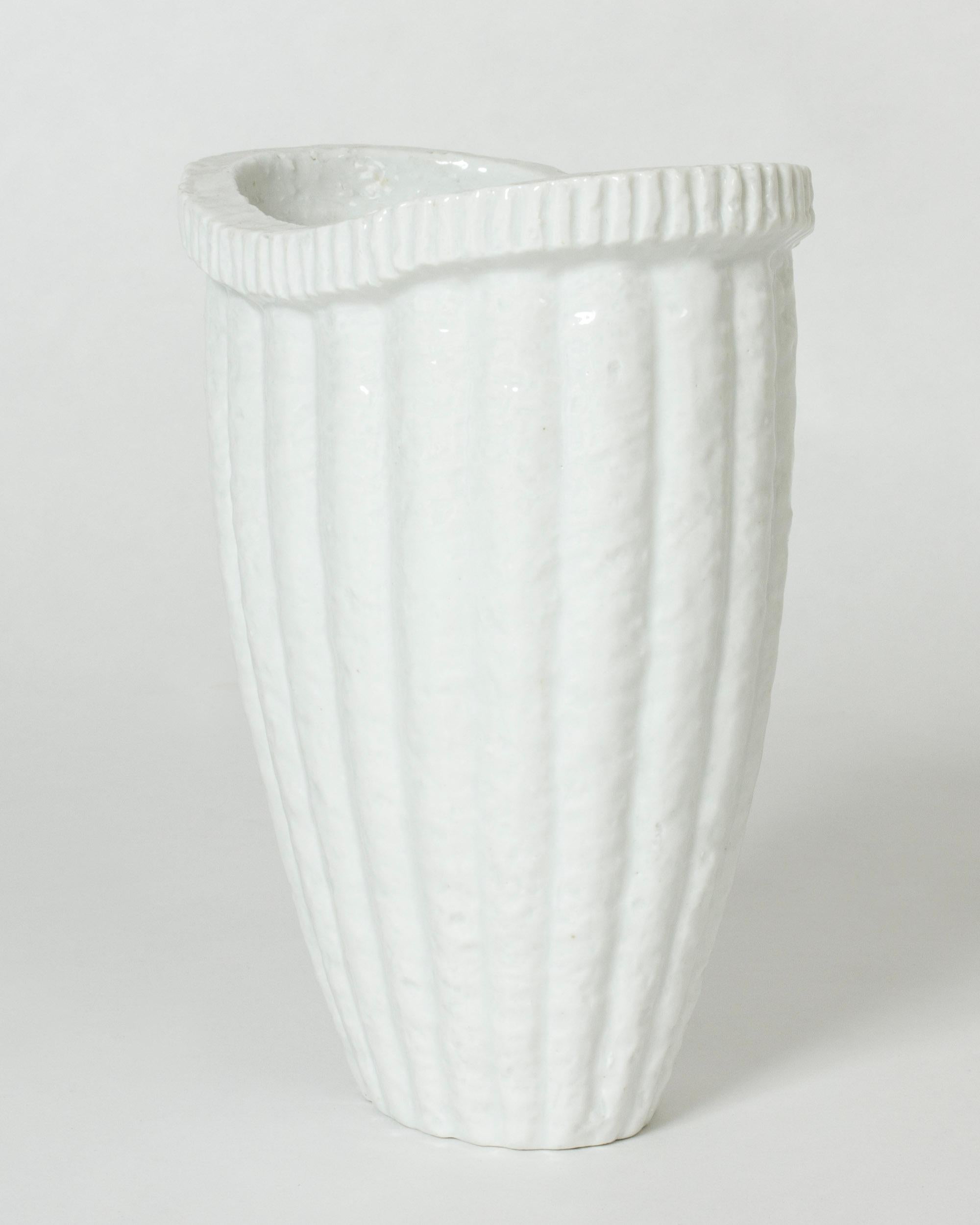 Elegant “Chamotte” stoneware vase by Gunnar Nylund, in a stately form. Made in a technique where crushed earthenware is mixed into the stoneware.

Rörstrand introduced Gunnar Nylund’s chamotte stoneware series including a number of vessel designs in