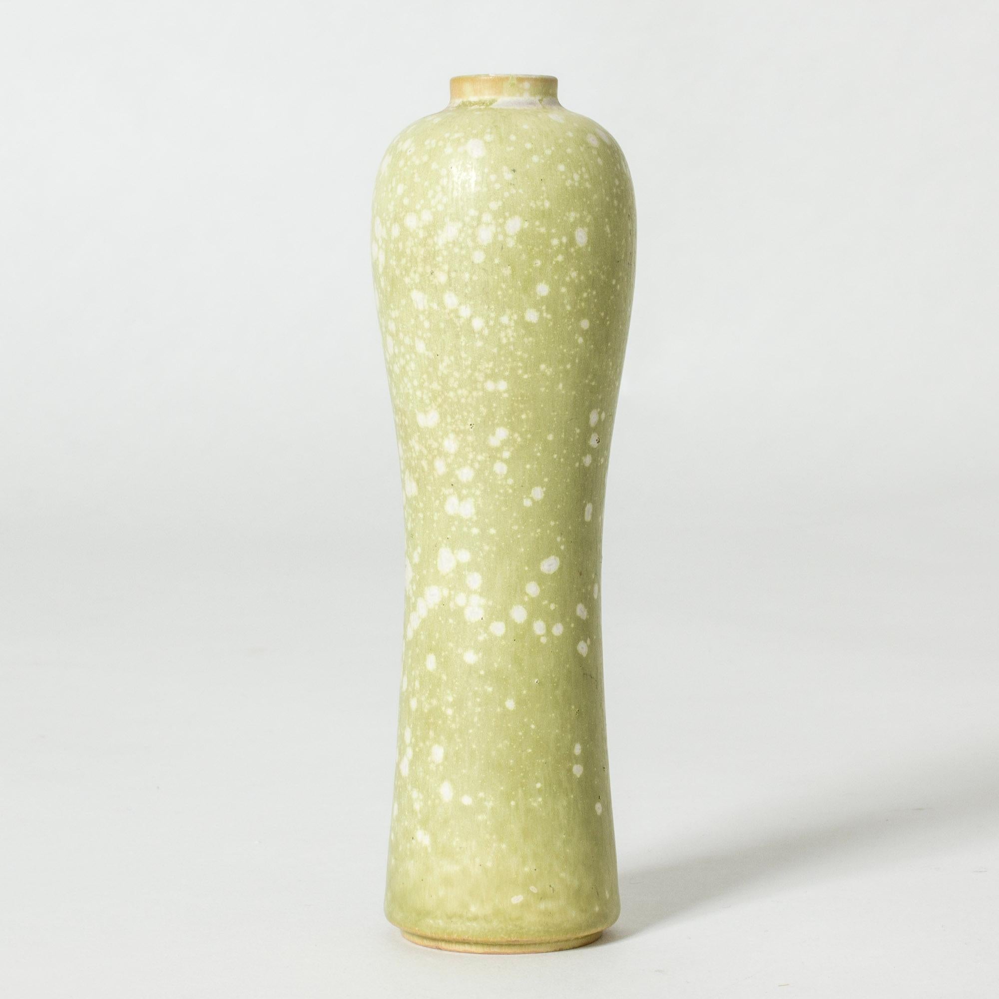 Lovely stoneware vase by Gunnar Nylund, in a curvesome, organic form form. Glazed pale green with a white “Mimosa” pattern.

Gunnar Nylund was one of the most influential ceramicists and designers of the Swedish mid-century period. He was