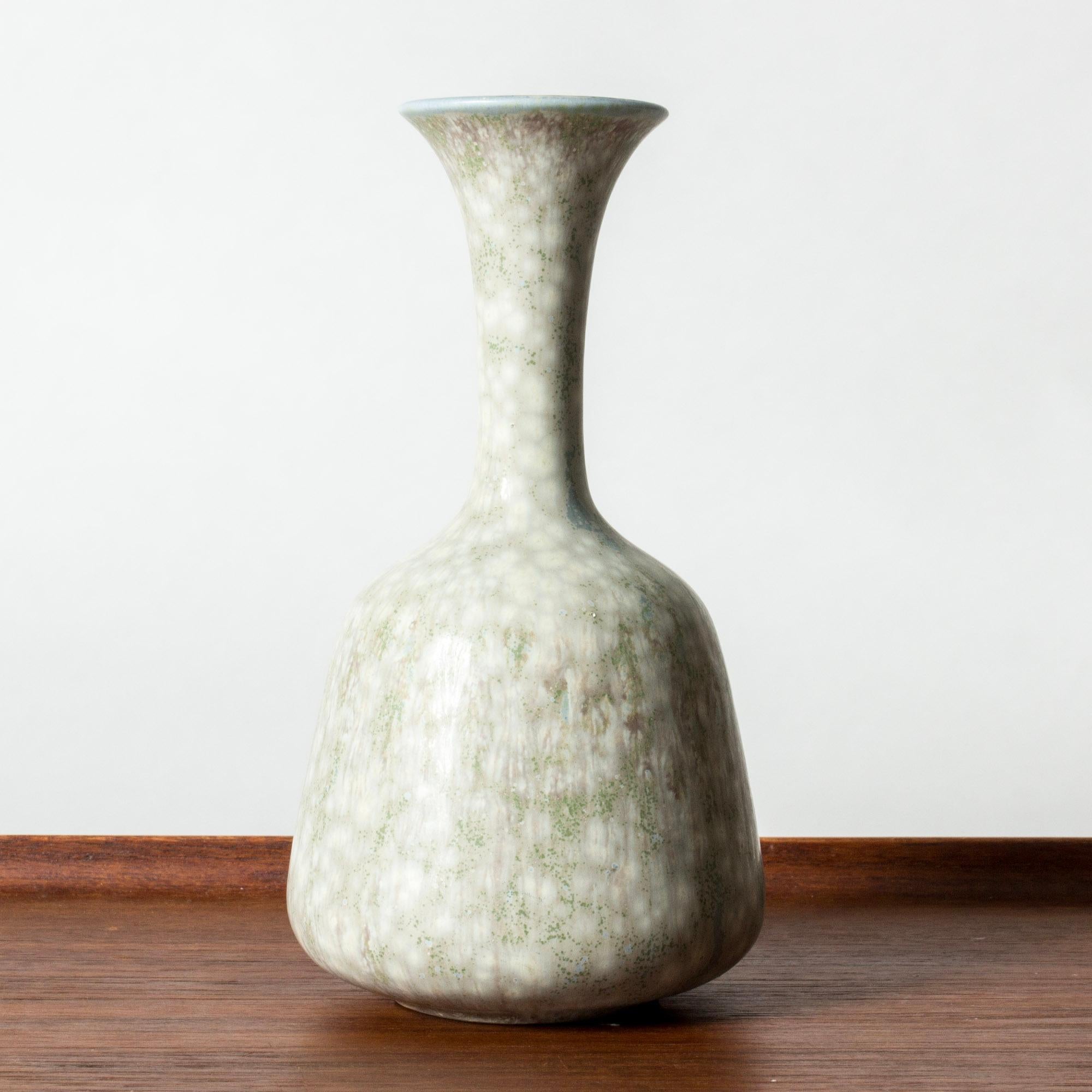 Beautiful stoneware vase by Gunnar Nylund, in a plump form with a slender neck. Glazed pale greenish blue with a white “Mimosa” pattern.

Gunnar Nylund was one of the most influential ceramicists and designers of the Swedish mid-century period. He