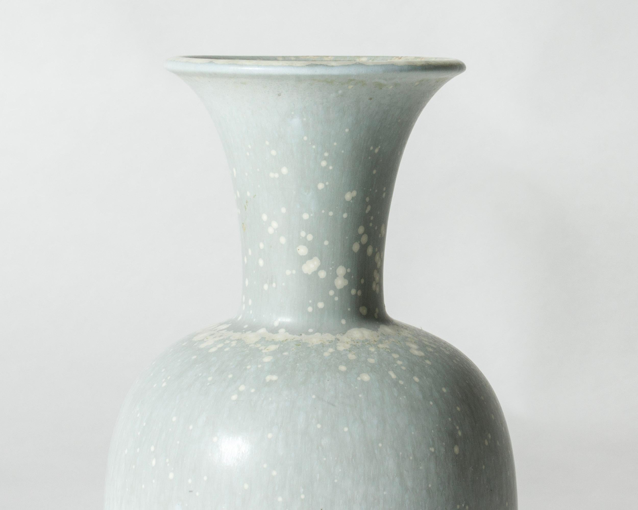 Beautiful, large stoneware vase by Gunnar Nylund, in a classic form. Glazed pale blue with “Mimosa” pattern.

Gunnar Nylund was one of the most influential ceramicists and designers of the Swedish mid-century period. He was Rörstrand’s creative