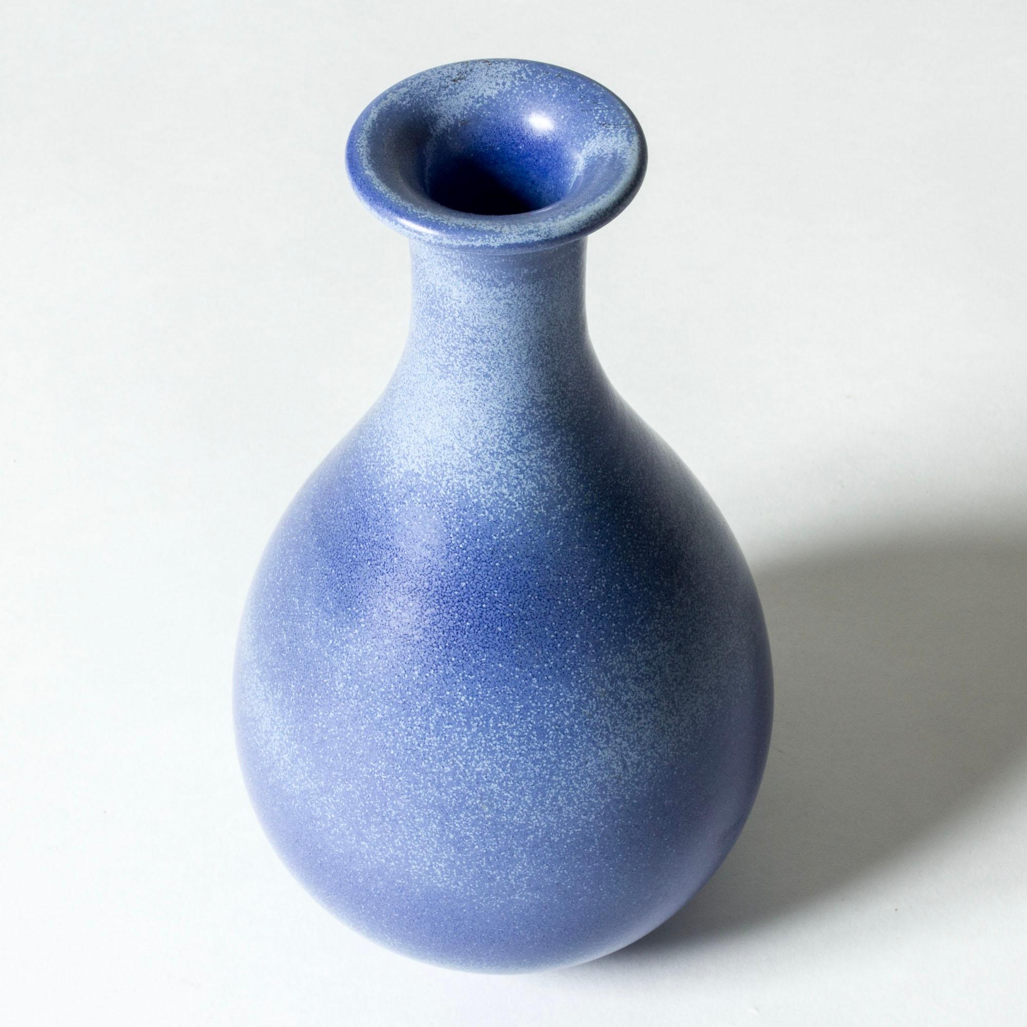 Stoneware vase by Gunnar Nylund, in a beautiful, curvesome form. Glazed sky blue, with a cloudy white, organic pattern.

Gunnar Nylund was one of the most influential ceramicists and designers of the Swedish mid-century period. He was Rörstrand’s