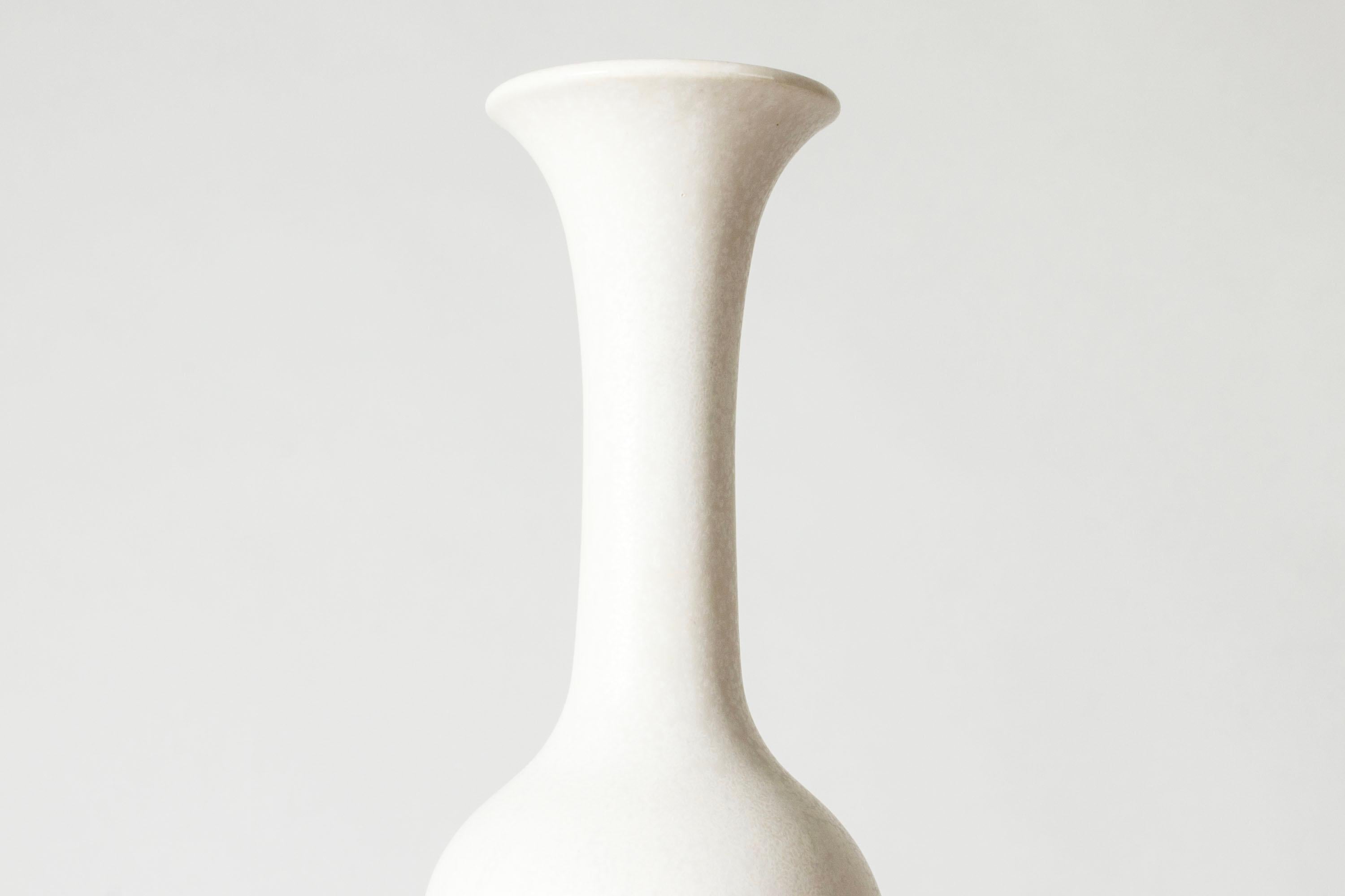 Beautiful stoneware vase by Gunnar Nylund, in an elegant, sleek form. Glazed white with a subtle “Mimosa” pattern.

Gunnar Nylund was one of the most influential ceramicists and designers of the Swedish mid-century period. He was Rörstrand’s