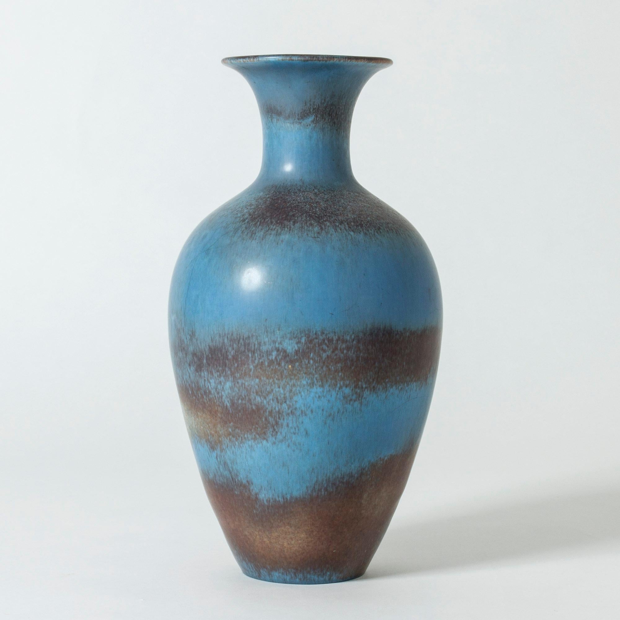 Large stoneware floor vase by Gunnar Nylund in a classic shape. Beautiful, vibrant blue glaze blending into brown and purple.