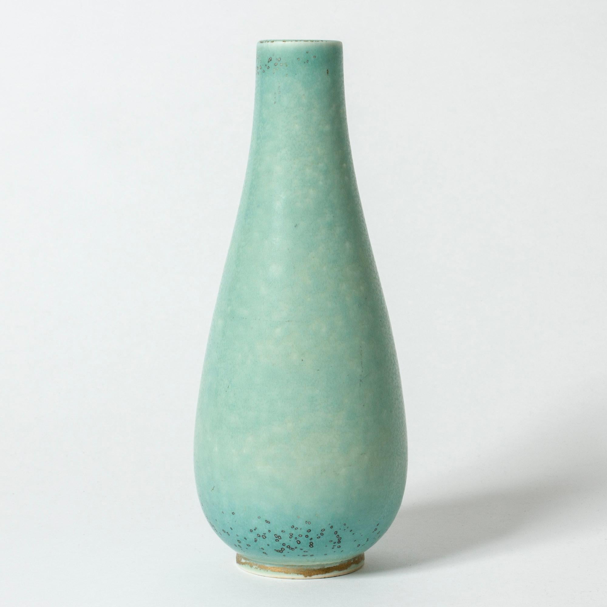 Lovely stoneware vase by Gunnar Nylund, in a sleek form. Pale celadon green glaze with “Mimosa” flecks.

Gunnar Nylund was one of the most influential ceramicists and designers of the Swedish mid-century period. He was Rörstrand’s creative leader