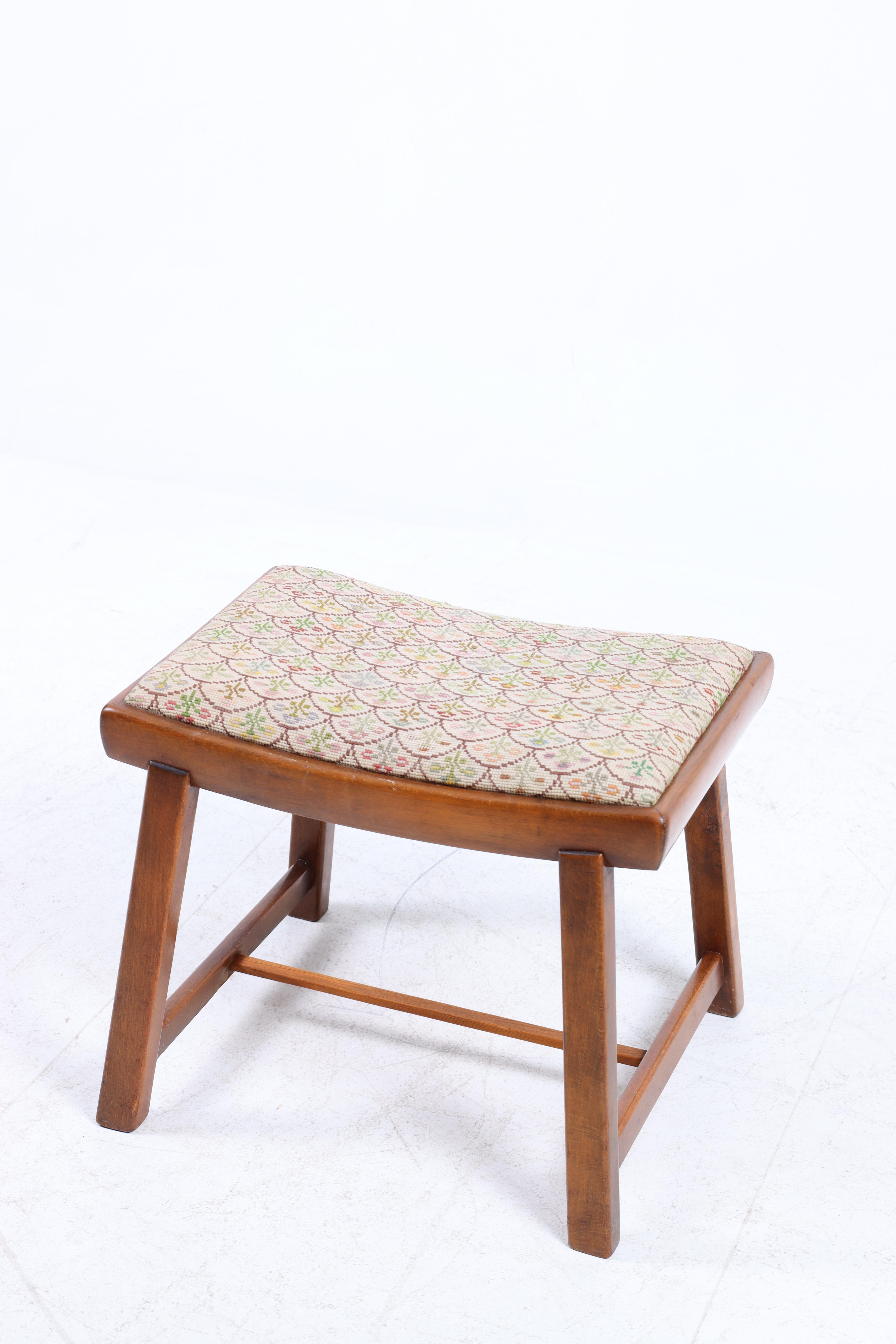 Stool in beech with fabric seat. Designed and med in Denmark, 1950s.