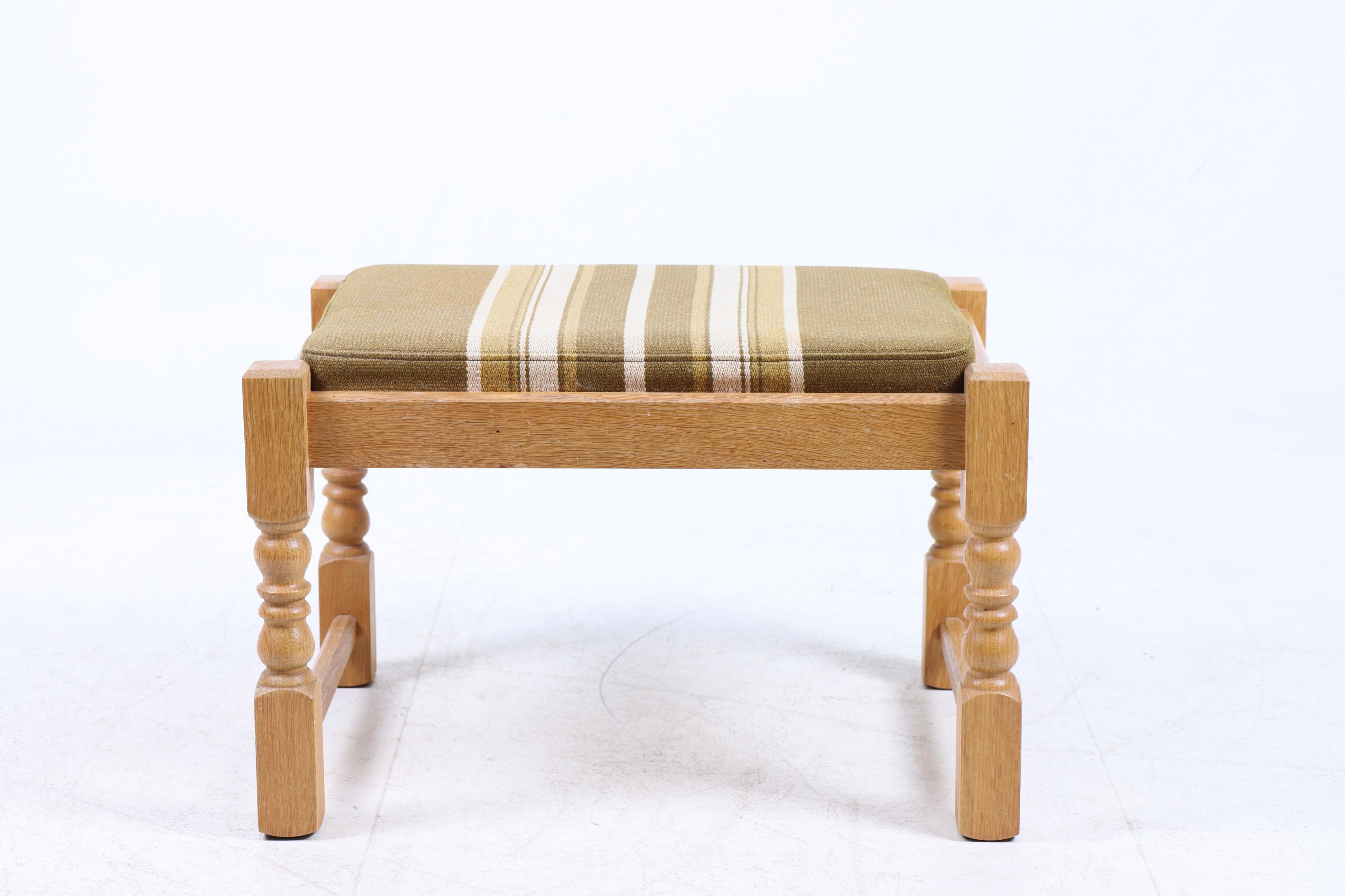 Stool in solid oak and fabric, designed made in Denmark, 1950s.