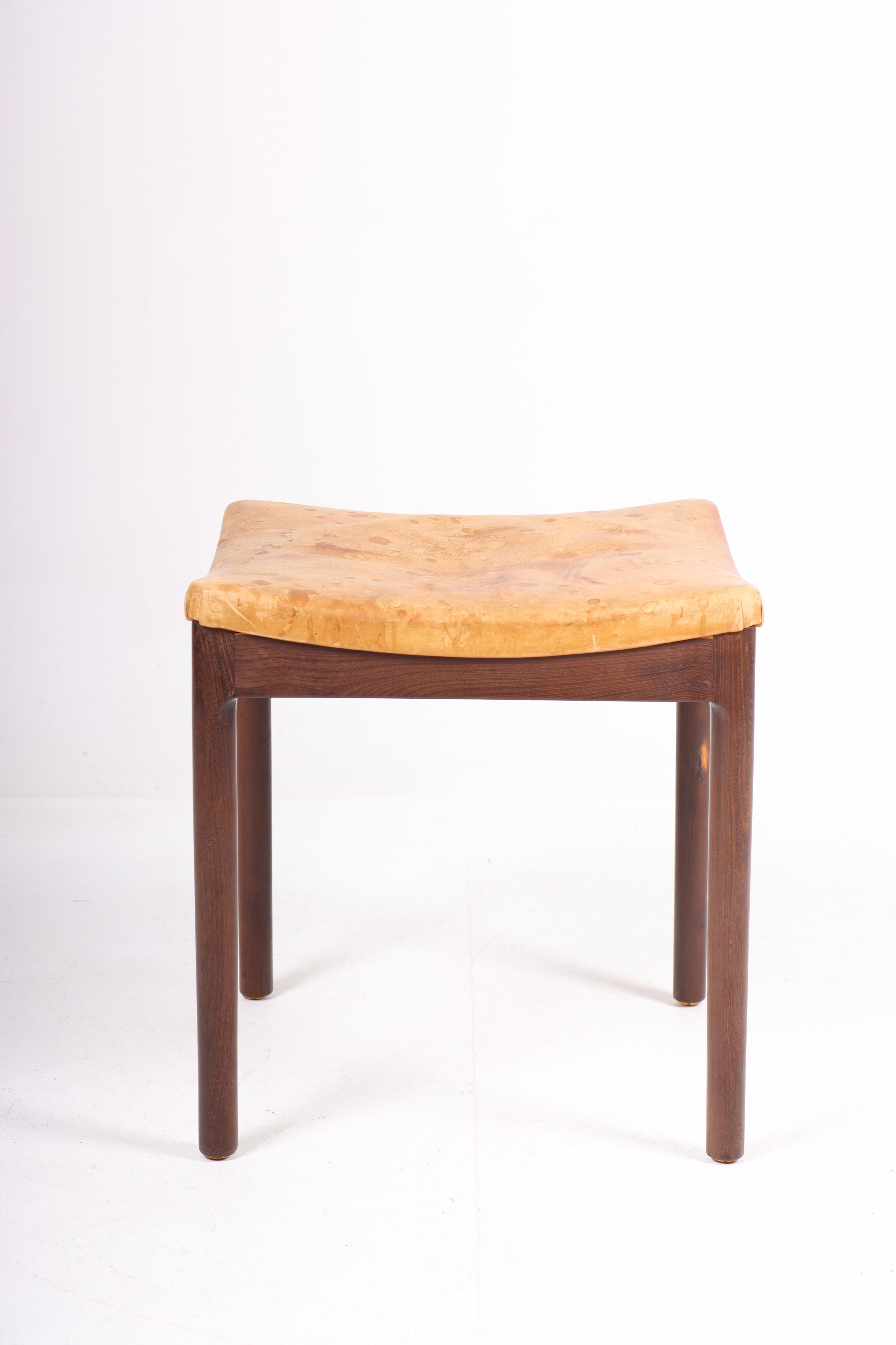 Stool in patinated leather and solid stained oak frame, designed and made in Denmark.