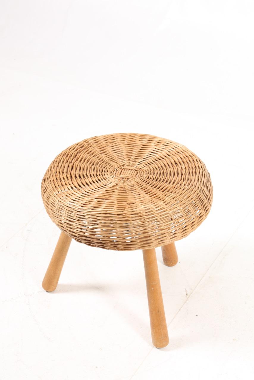 Stool in beech and seat in cane. Made in Denmark in the 1950s.