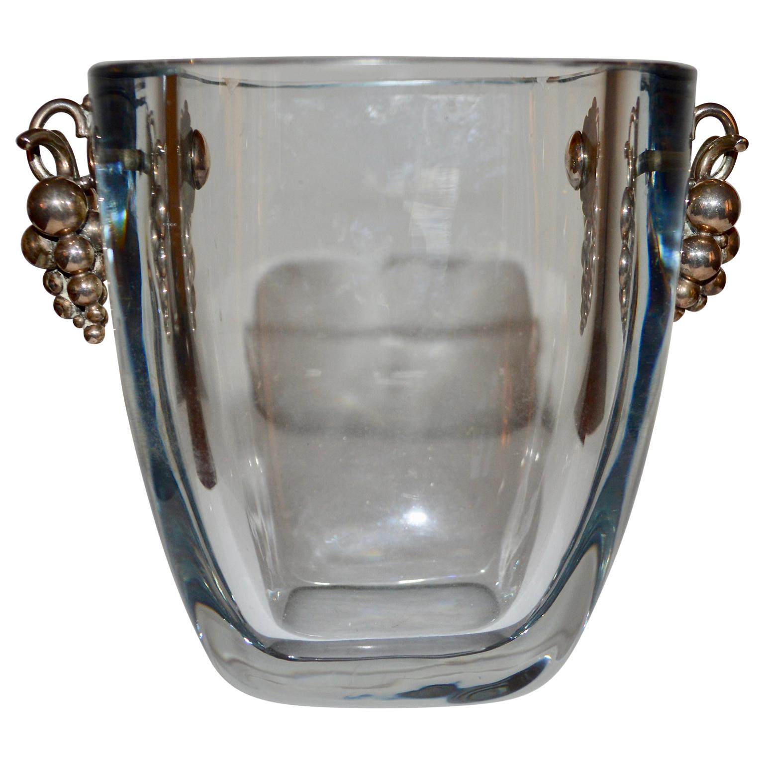 Mid-Century Modern blue tinted glass ice bucket with silver handle decorated with grapes. Hallmarked and stamped S925. The ice bucket in translucent glass. Attributed to Stromberg, that was founded in Sweden by the Stromberg family in 1876 and 1976,