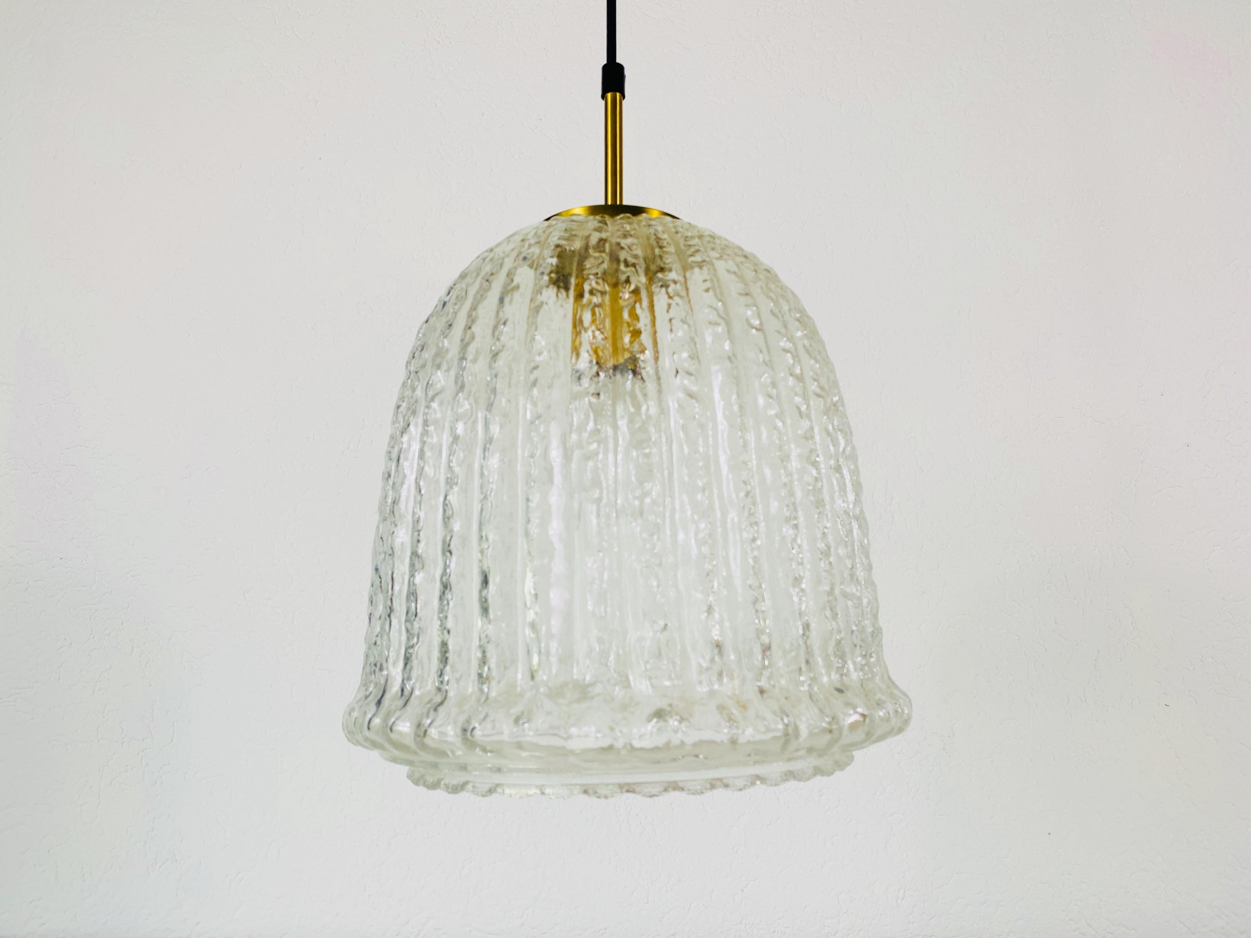 A Mid-Century Modern pendant lamp by Glashütte Limburg made in the 1960s in Germany. It is fascinating with its beautiful shape. Structured glass with brass top.

The light requires one E27 light bulb. Very good vintage condition.

Free