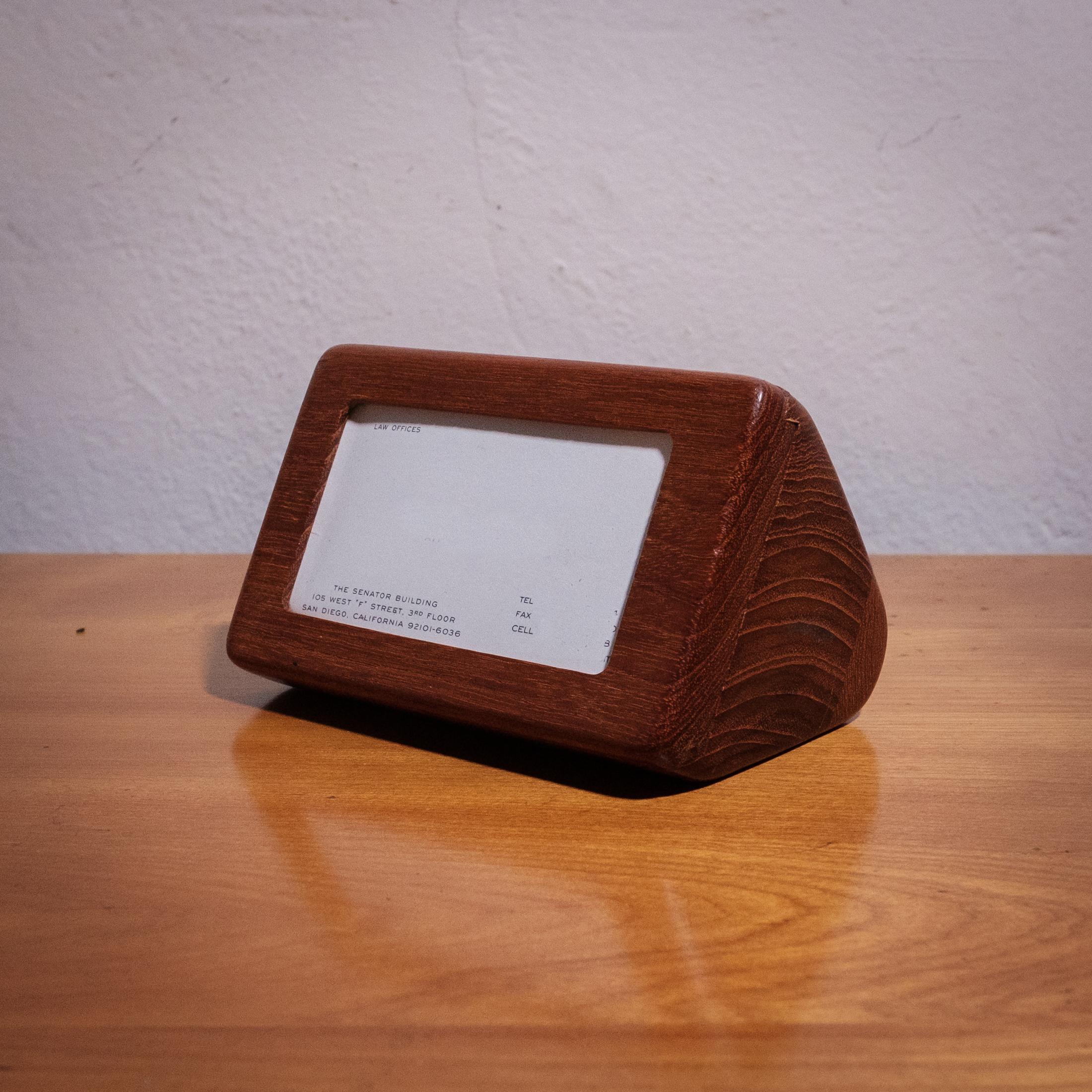 Mid-century studio craft walnut business card holder and display. The front section slides to insert a standard 3.5 inch by 2 inch size card for display and a slot in the back holds a small stack of cards for distribution. A beautifully-crafted