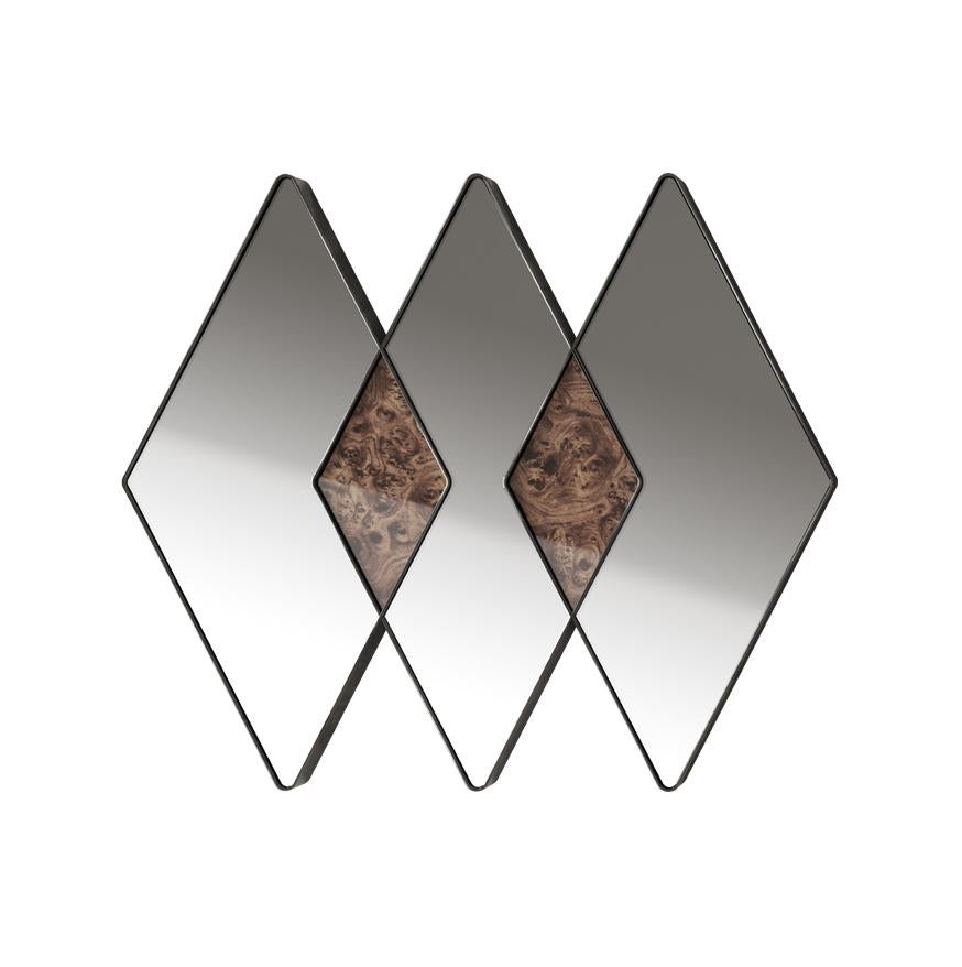 The lines of blaze chase and intertwine, a mirror that becomes a painting and a decorative element thanks to the alternation of mirrored surfaces and wood. The chromed steel of the profile emphasizes its contemporary allure an defines the geometric