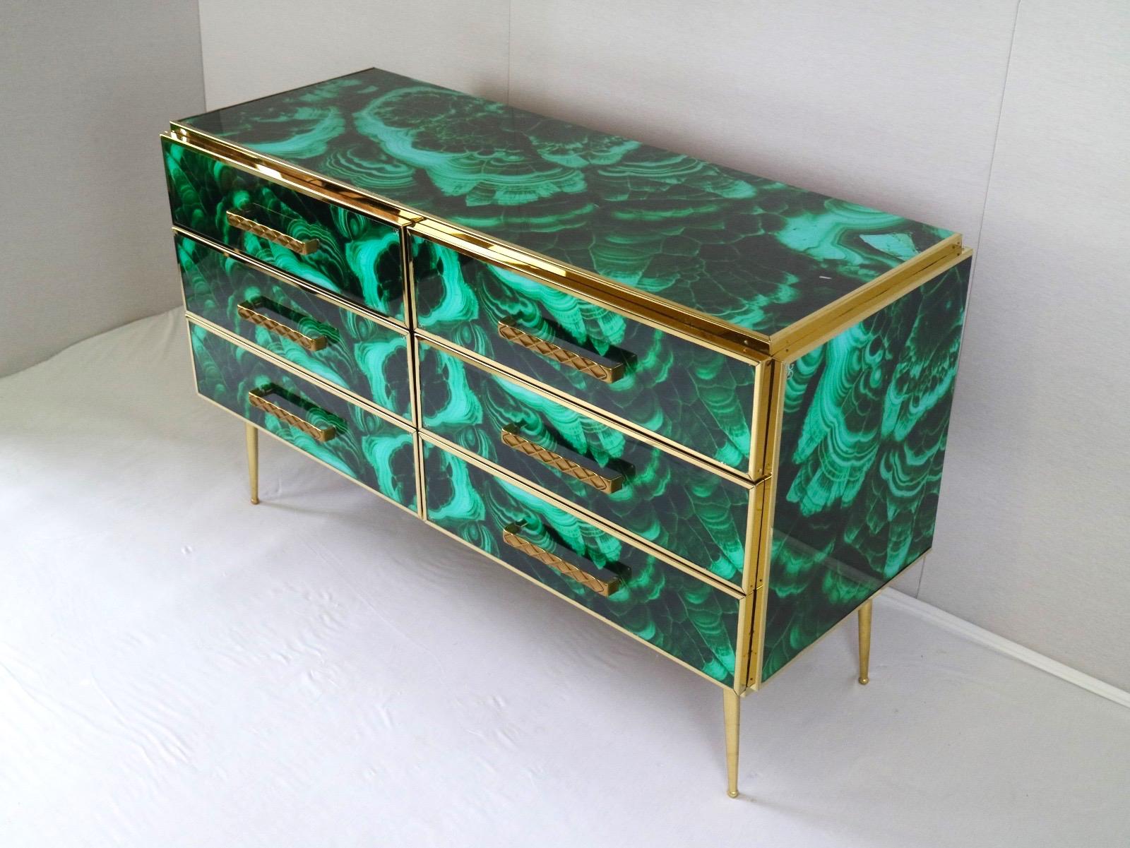 Striking brass frame and hand-cut Malachite imitation Murano glass Commode or chest of drawer, raised on special brass legs. 
Handmade by a master artisan.