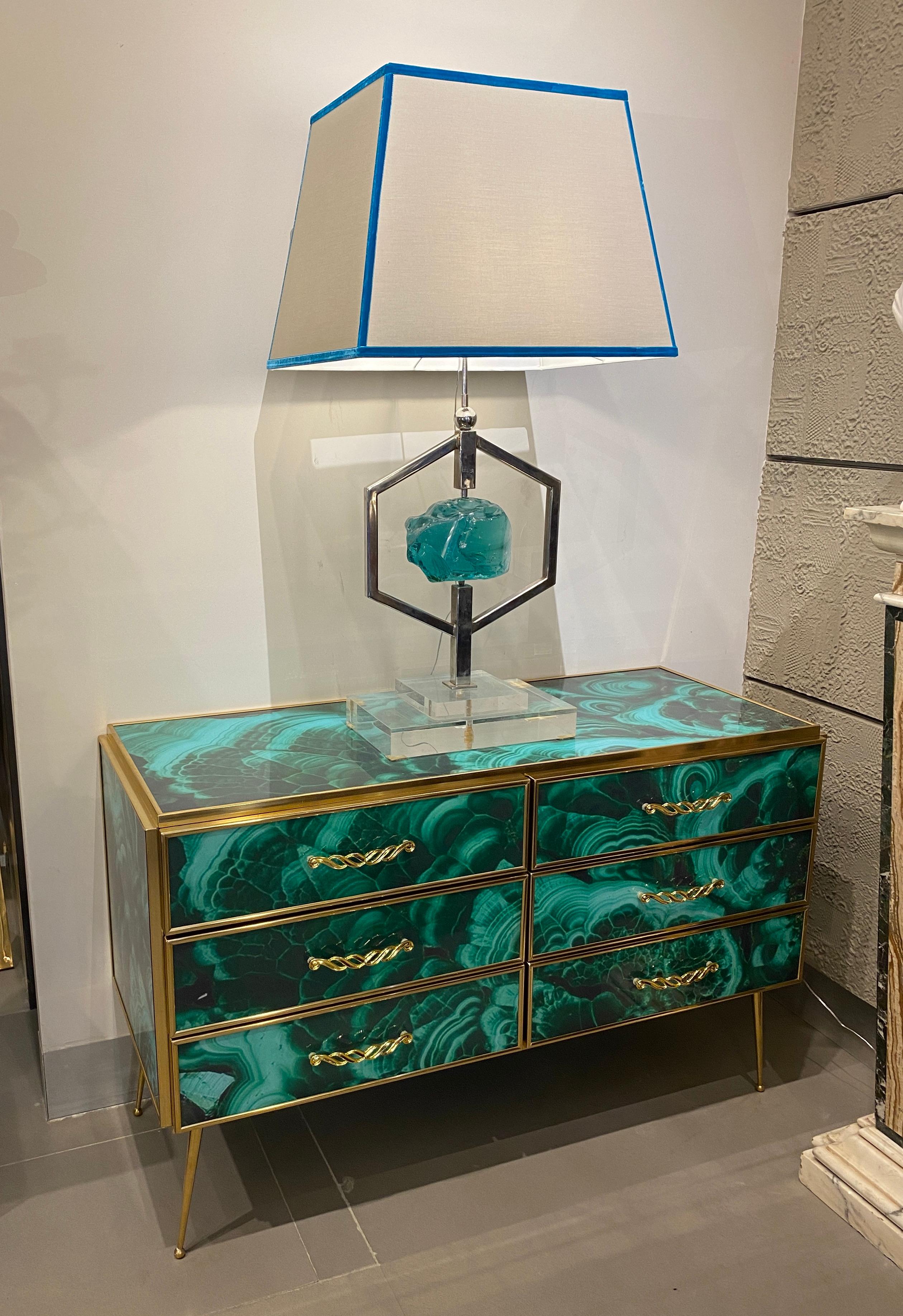 Striking brass frame and hand-cut Malachite imitation Murano glass Commode or chest of drawer, raised on special brass legs. 
Handmade by a master artisan.
Price is for 1 item .
We will deliver professionally packed in a wooden case. 