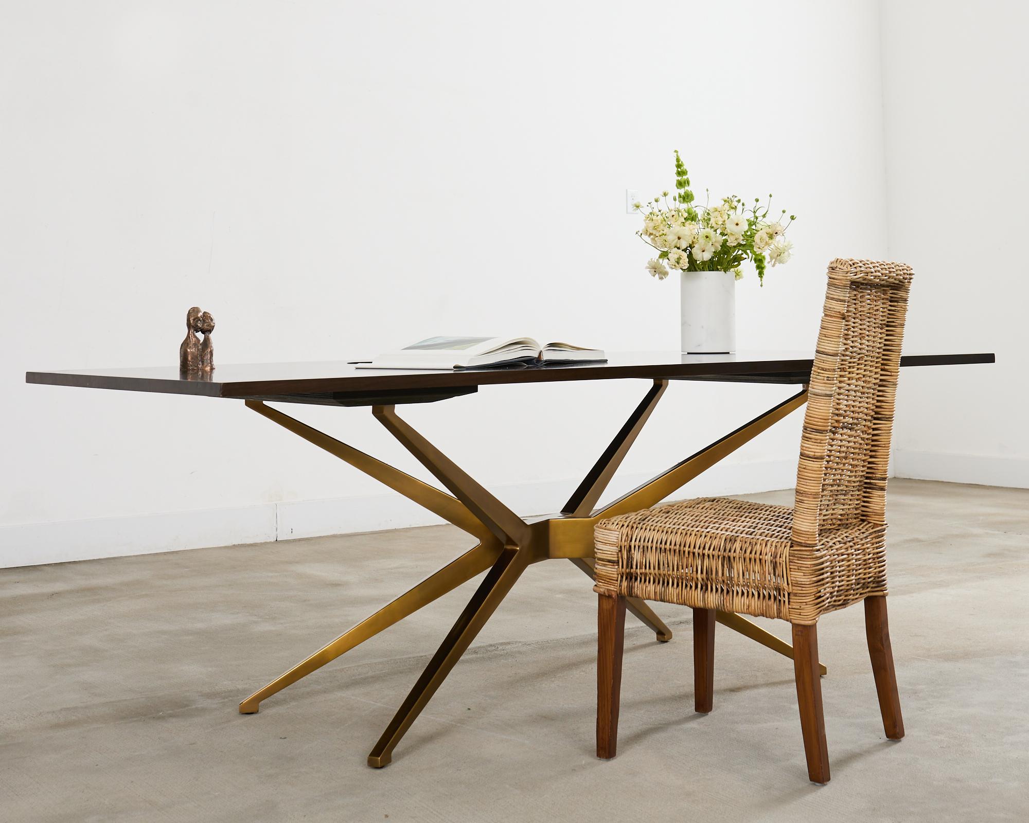 Dramatic mid-century modern space age designed desk featuring a spider leg polished brass base. Contemporary desk produced by Restoration Hardware after a 1960's Italian design. The cast brass base is hand-polished and topped with an American walnut