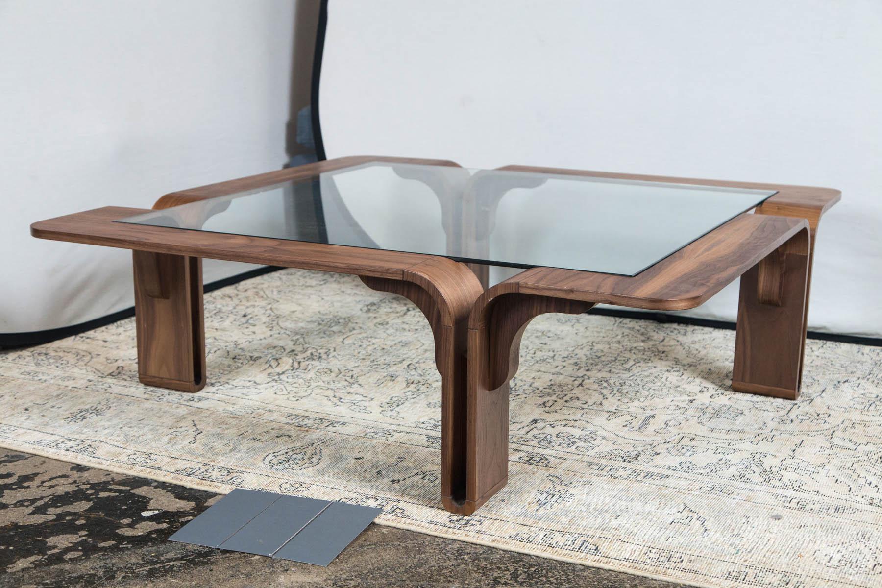 Glass top wood framed square coffee table.