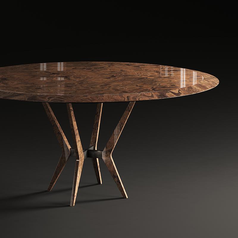 A double core of briar-root and metal characterizes this large round table. The shaped top consists of the combination of an upper surface in briar-root and of a lower one in burnished metal. This same alternation of materials defines the geometric