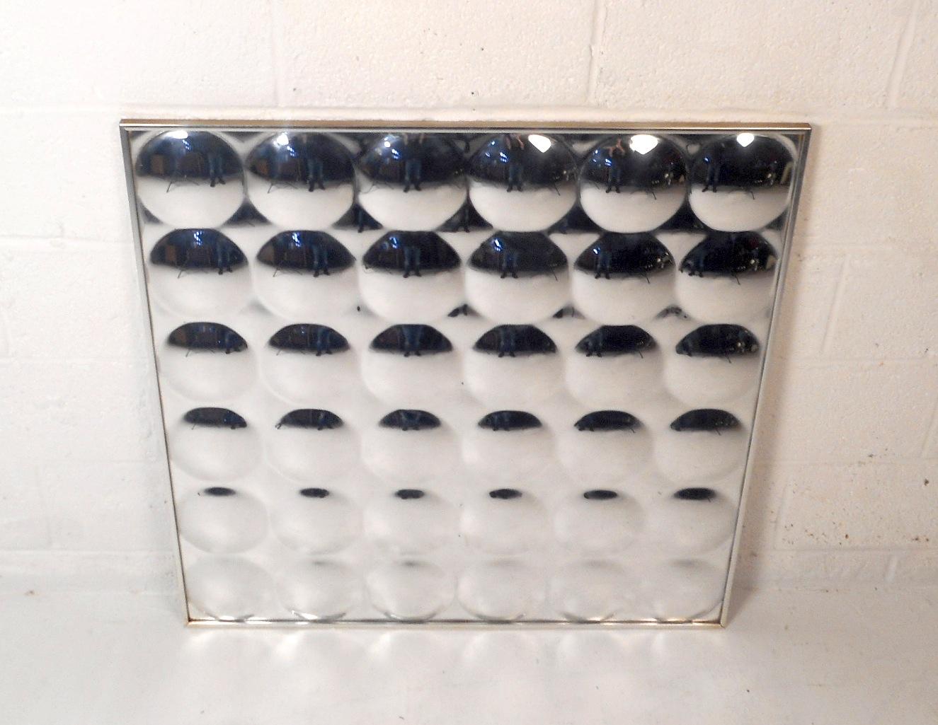 This unique vintage style wall art is composed of 36 mirrored bubbles on a chrome frame. The eye-catching plexi-view mirrors reflect everything in the room and are sure to be a conversation starter in any setting. Please confirm item location (NJ or