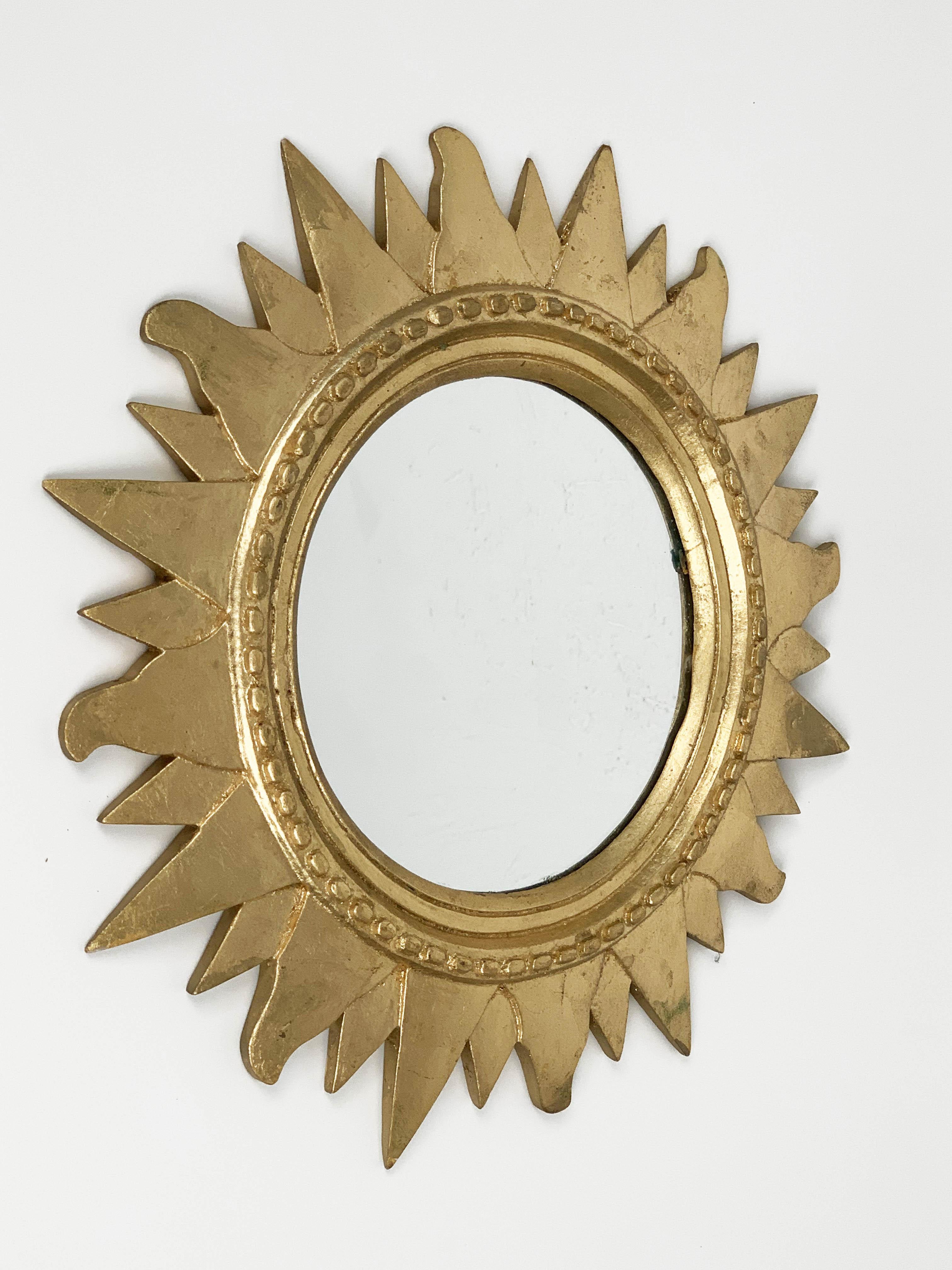 Italian gilded plastic sunburst mirror, produced during 1970s. 

It is a round wall mirror made of gold-plated styrofoam, in amazing conditions and with a delicate and nice patina.

The item is great for completing a colored midcentury