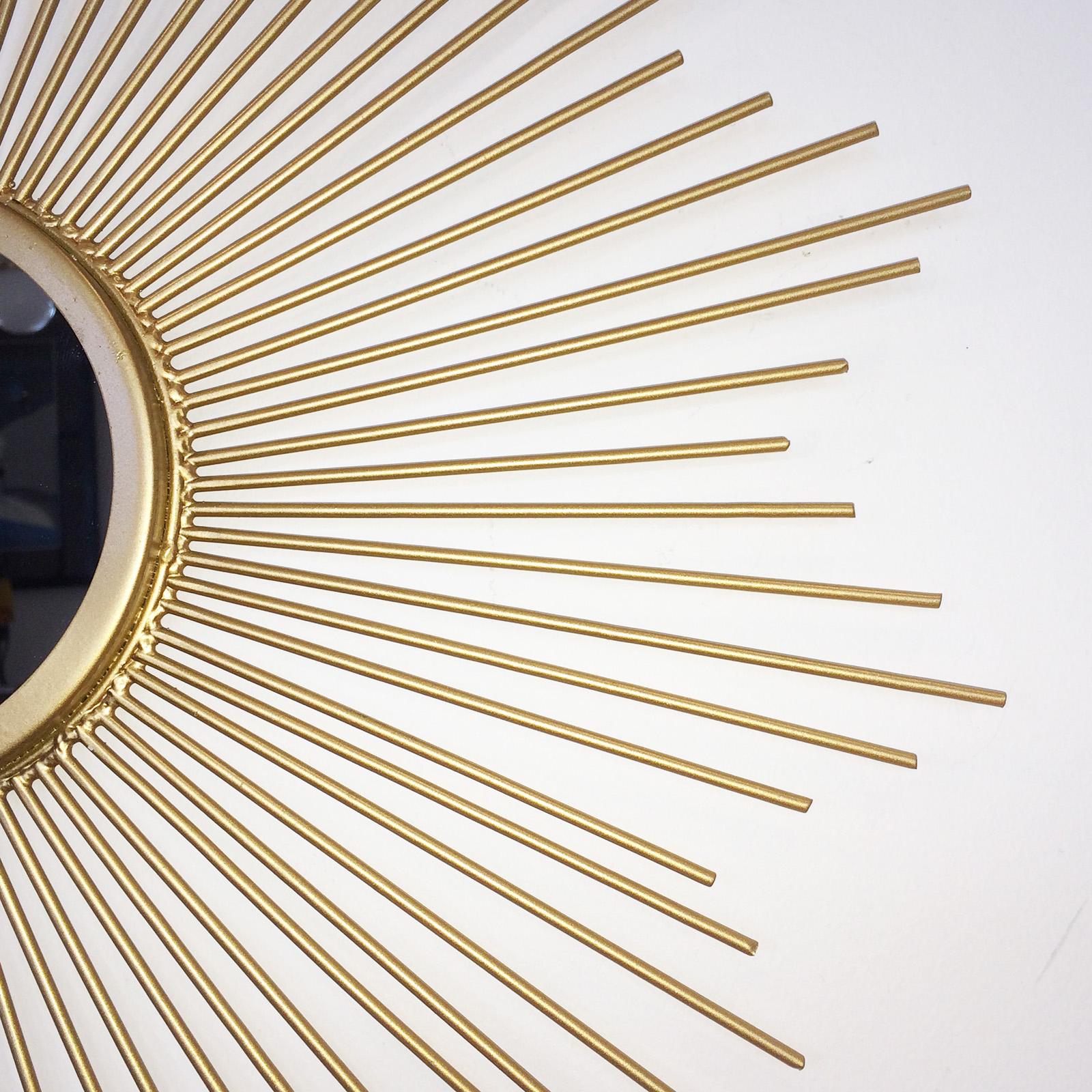 Midcentury sunburst shape, flat mirror with gilt tapered solid rods creating a star shape. The rear is fitted with a tab, recessed to take a simple wall screw or nail to hang the mirror. This piece is totally perfect with no damage or repairs. The
