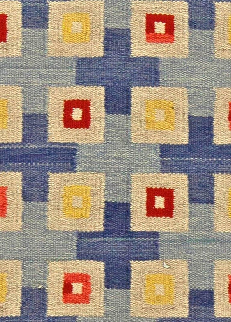 Midcentury Swedish blue, red, yellow and beige flat-woven wool rug
Size: 5'5