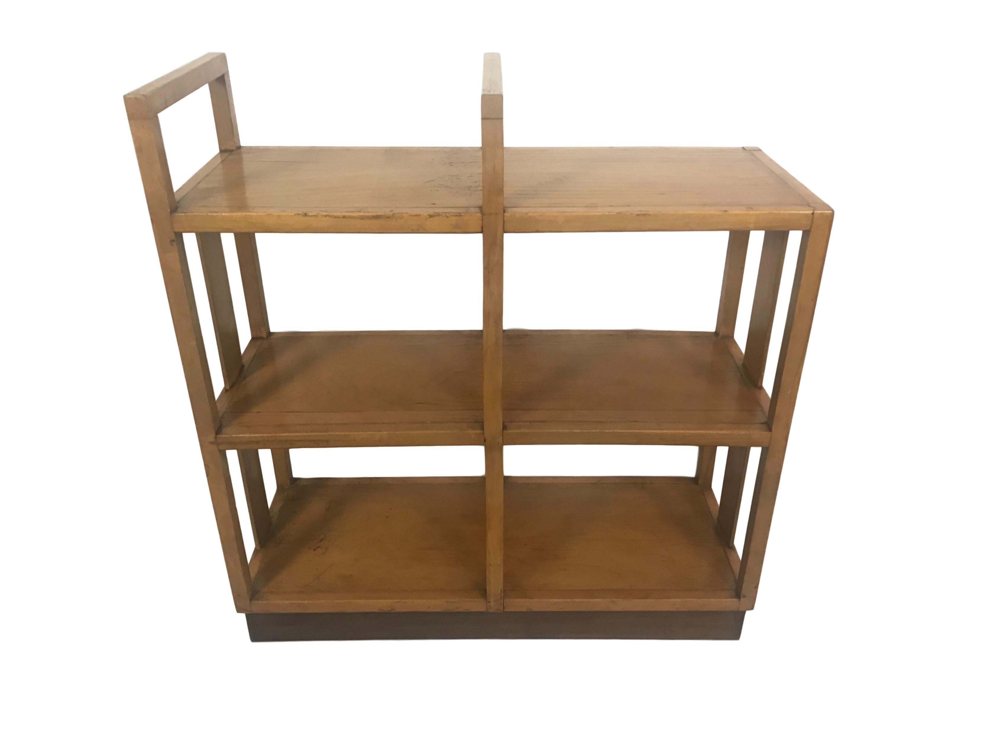 This is a midcentury bookshelf from a public library in Sweden with dark walnut base.