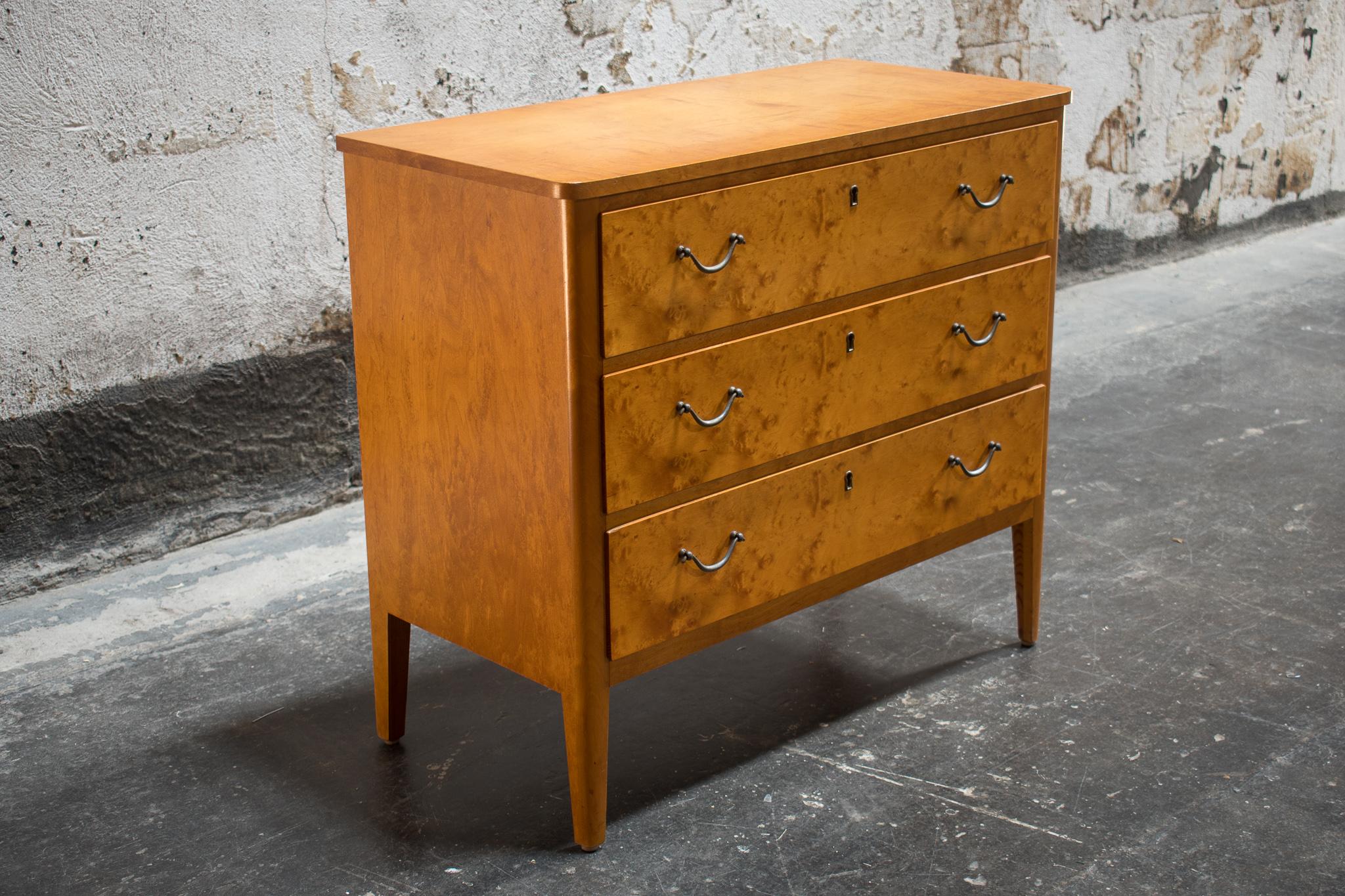 Handsome three drawer chest made in Sweden of golden Birch. Perfect for storage of bedding or clothes. A lovely piece of furniture in any room.