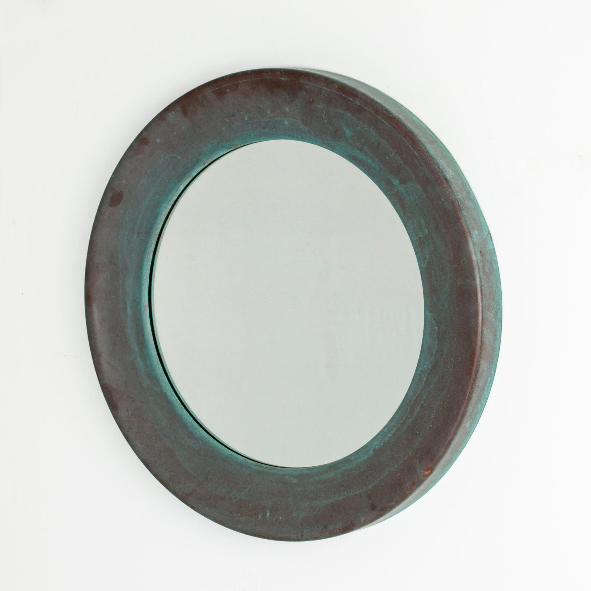 Large, round mirror from Glasmäster i Markaryd, made with a wide copper frame. Amazing green patina with hints of brown.