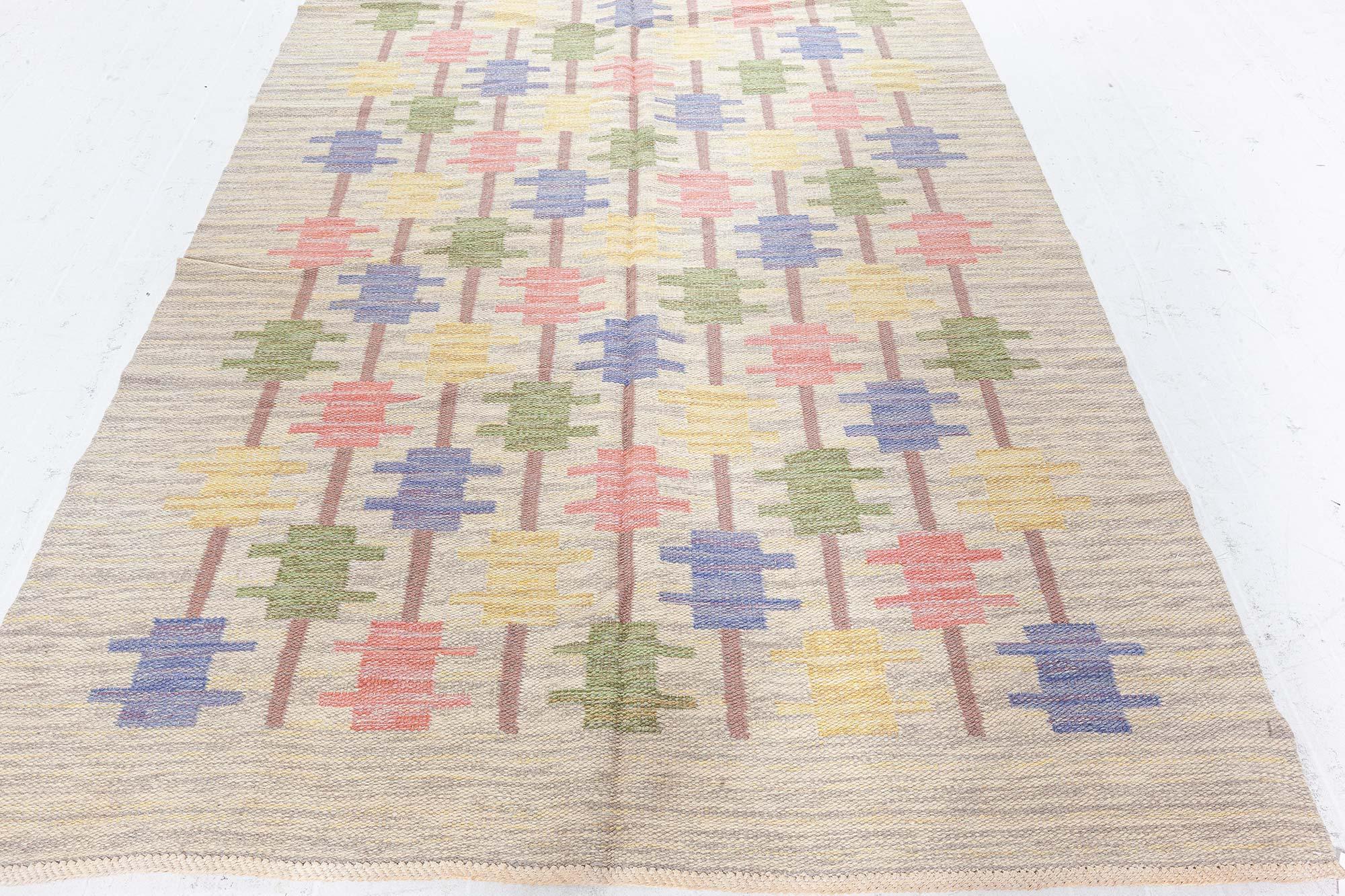 Mid-20th century Swedish beige, blue, green, red and gray flat-weave wool rug
Size: 5'5