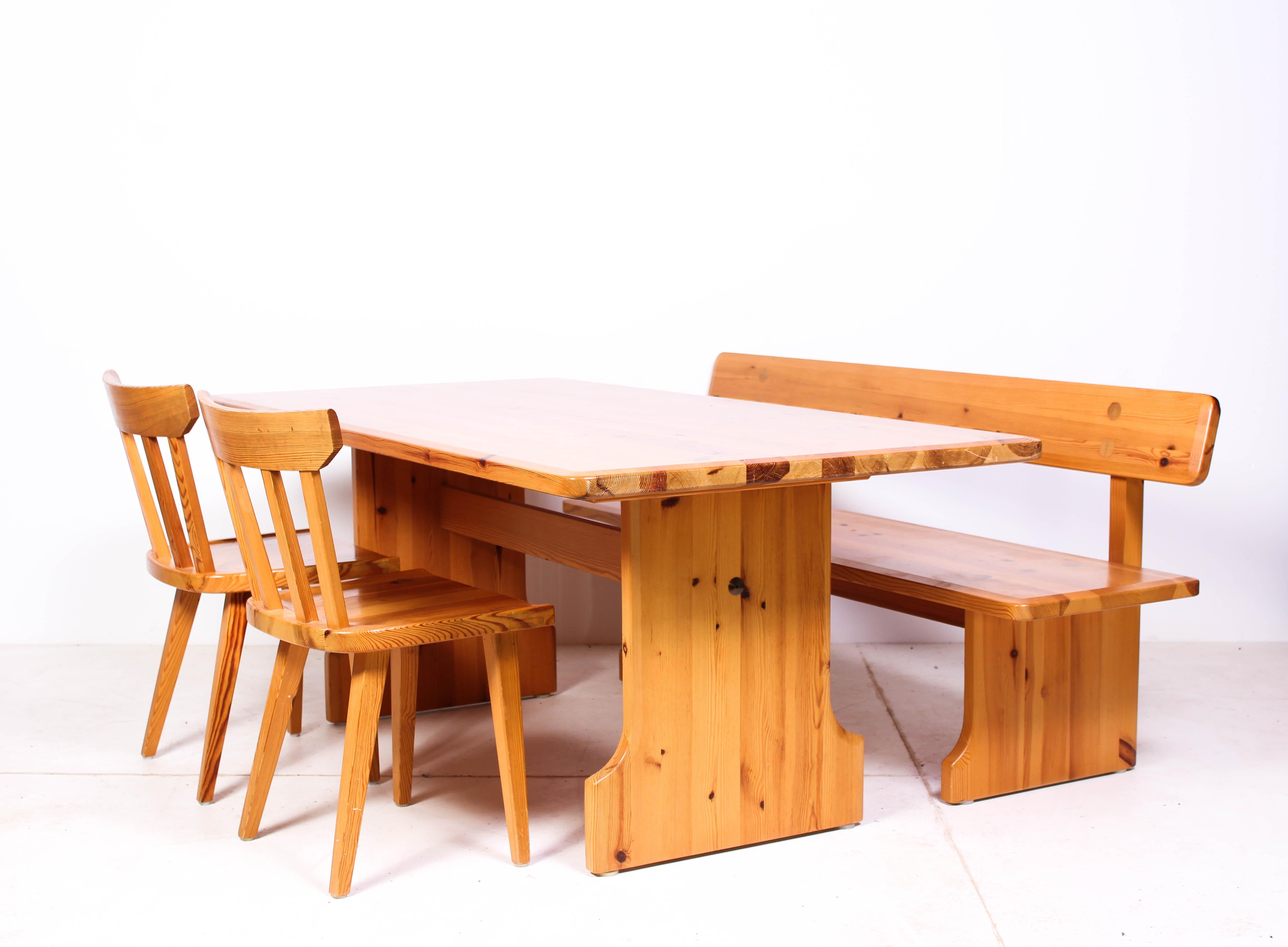 A set of dining table, two chairs and a bench made out of solid pine bu Karl Andersson & Söner. High quality and nice details, design by Carl Malmsten. The set is in very good vintage condition with some signs of usage consistent with age and use.