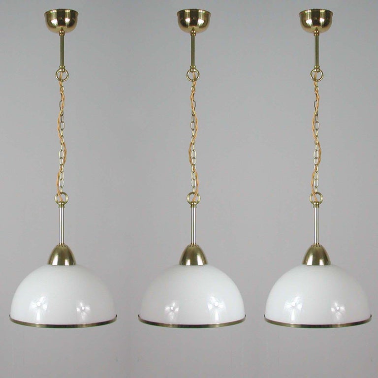 This elegant midcentury pendant was designed and made in Sweden in the 1950s. The light features a white opaline glass lampshade and brass hardware. Good vintage condition with one E27 socket per lamp.

The lamps have been rewired for use in US