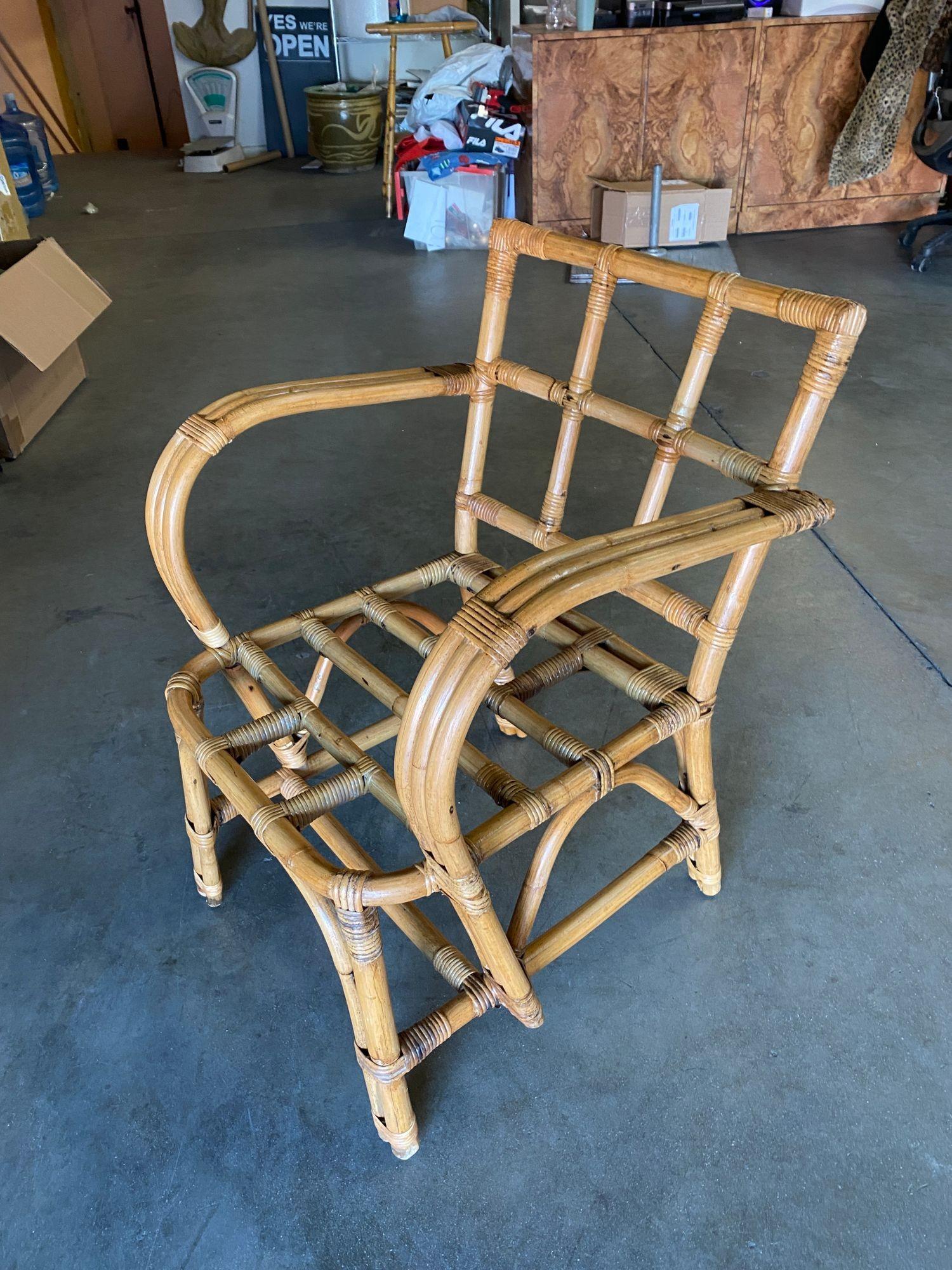 Vintage swoop arm rattan dining room chair featuring a triple pole back seatback forming in what is known as the Tic-Tac-Toe back and a unique swoop arm design. Seat Height: 14.5