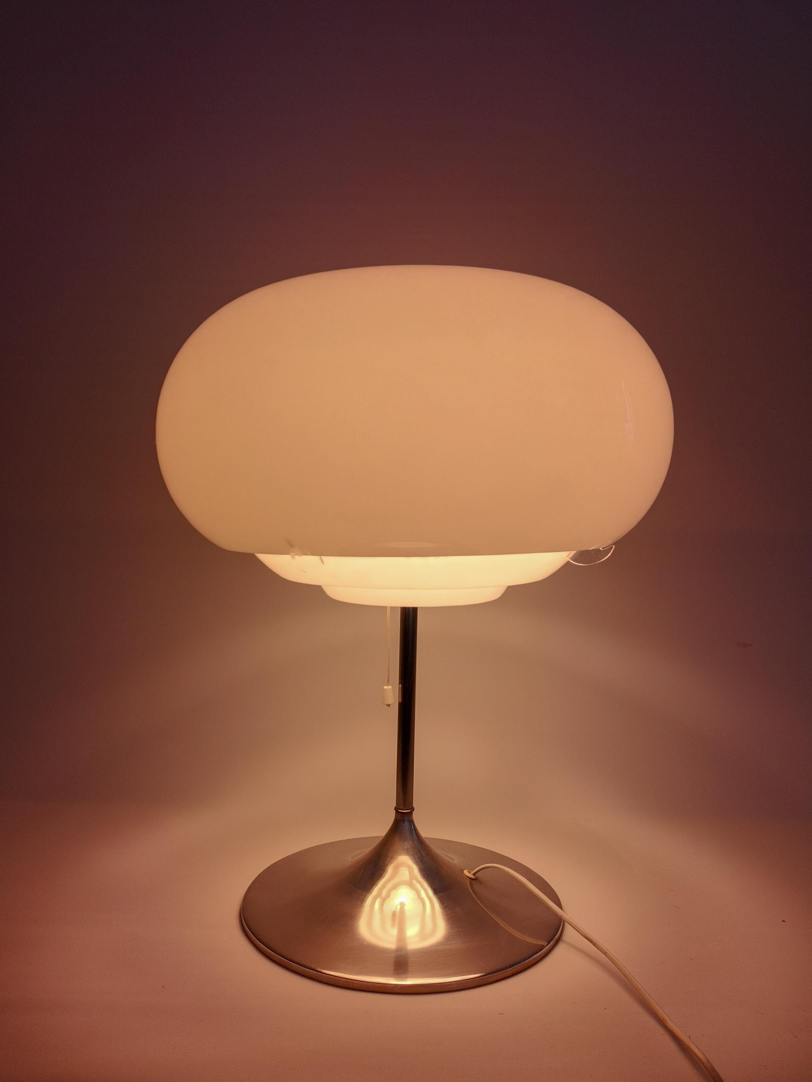 This rare and large Bergbom B-105 table lamp has an Art Deco look with the touch of Swedish midcentury. 
It has an Iron cast base with chrome foot and an acrylic lamp shade.

Good working condition

Measures: H 55 cm, D 45 cm.
 