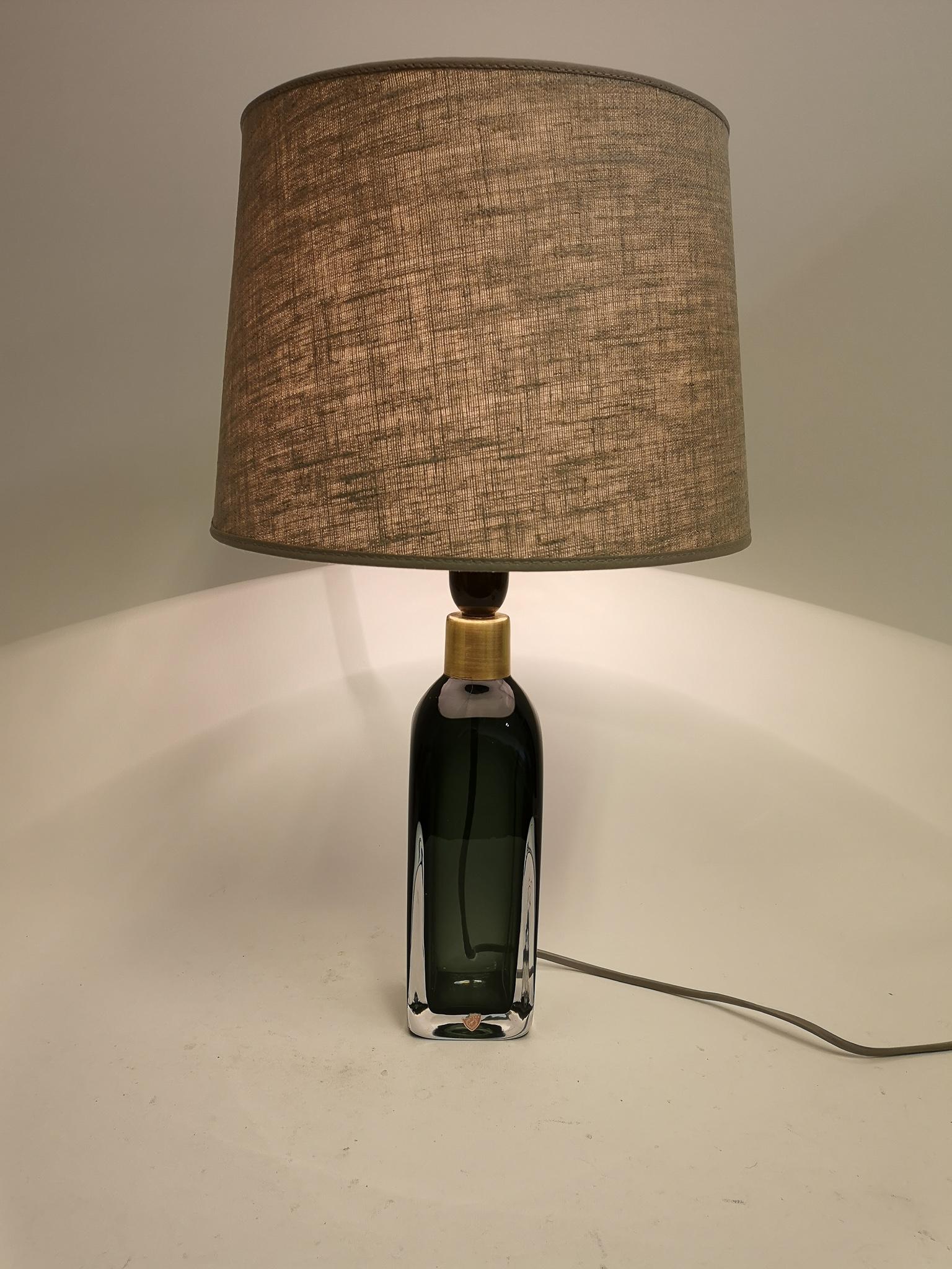 Table lamp in crystal, model RD1406 by Carl Fagerlund for Orrefors, Sweden.
The lamps have a stunning green color with brass details.

The shade can be included if buer wants.

Measures: H 34 cm W 8 cm with shade H 52 cm.
 