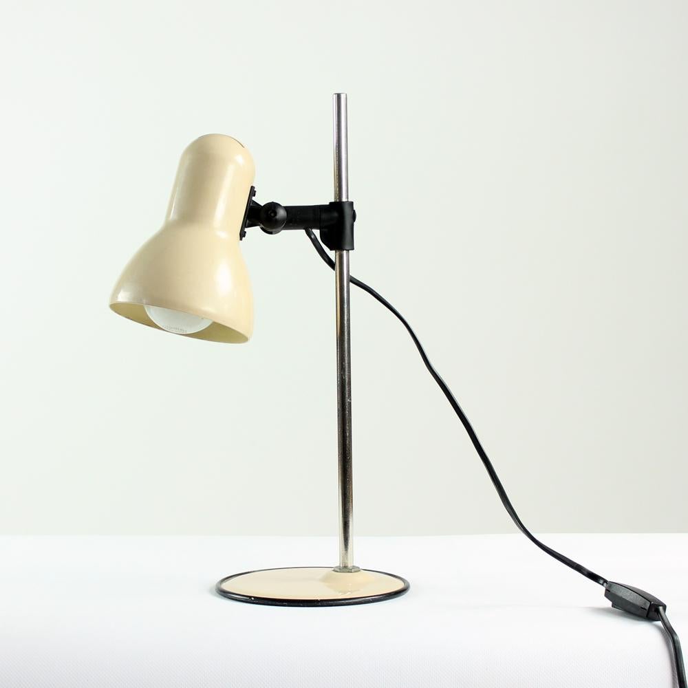 This is a beautiful table lamp with the typical design for midcentury era. Produced in Hungary by Elektrofém company in 1970s, original label still attached. The light is fully made of metal. The base and shield are in beige emanel finish. These two