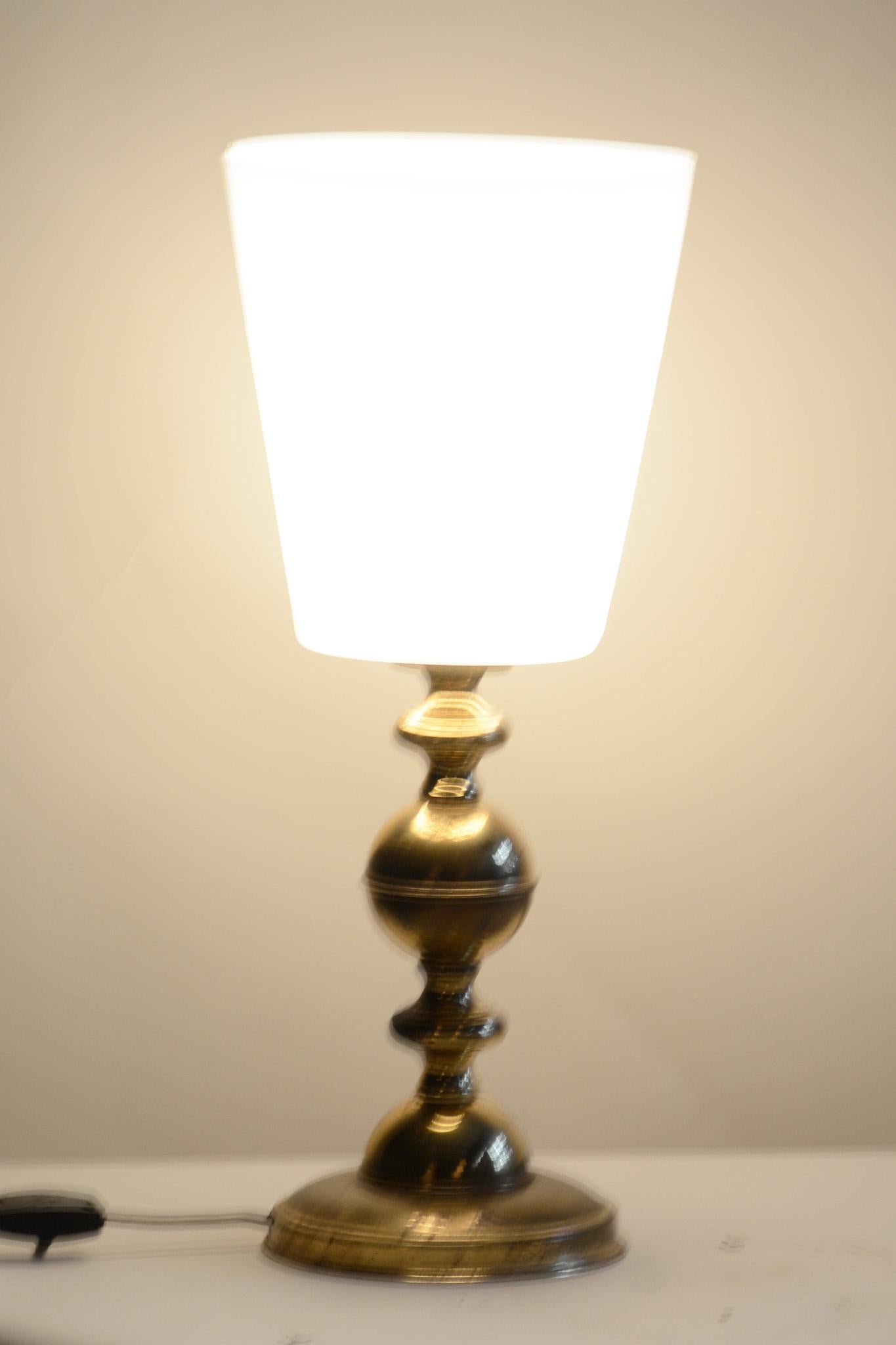 midcentury Table Lamp.

Period: 1960-1969
Source: Czechia 
Material: Milk Glass, Brass

Undamaged and fully functional.

This item features Classic Mid-Century Modern (MCM) design elements. Elements of MCM interior design include clean