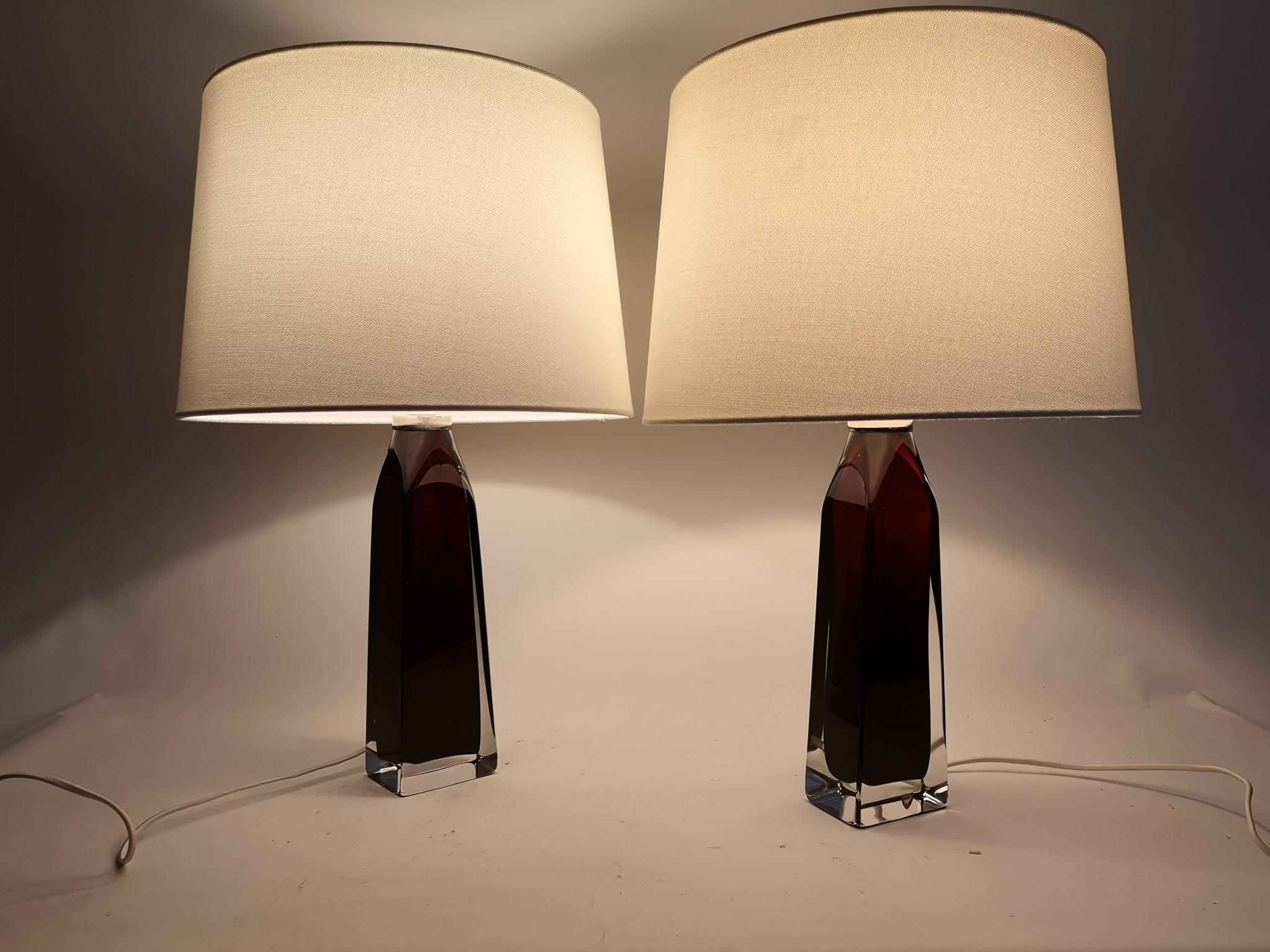 Table lamps in crystal, model RD1884 by Carl Fagerlund for Orrefors, Sweden.
The lamps have a stunning red color with clear glass, and chrome details.

The shade can be included if buyer wants.

Measures: H 37 cm, W 8 cm, with shade H 52 cm.
 