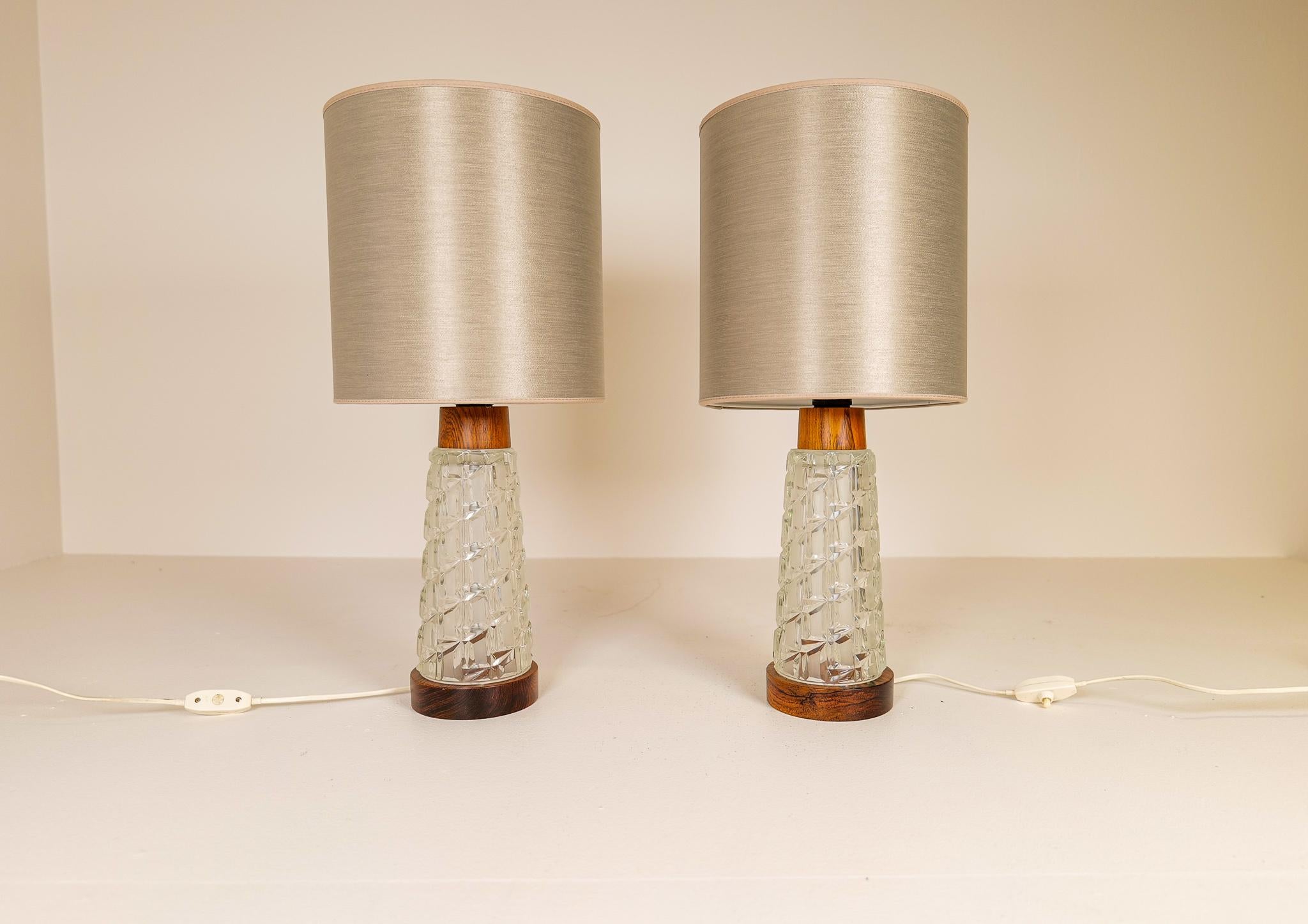 Wonderful midcentury lamps in teak and glass. 

Good working condition with all new shades.

Dimensions H 33 cm without shades and 58 with shades. Base diameter 12 cm and the shades diameter 25 cm.
 
 