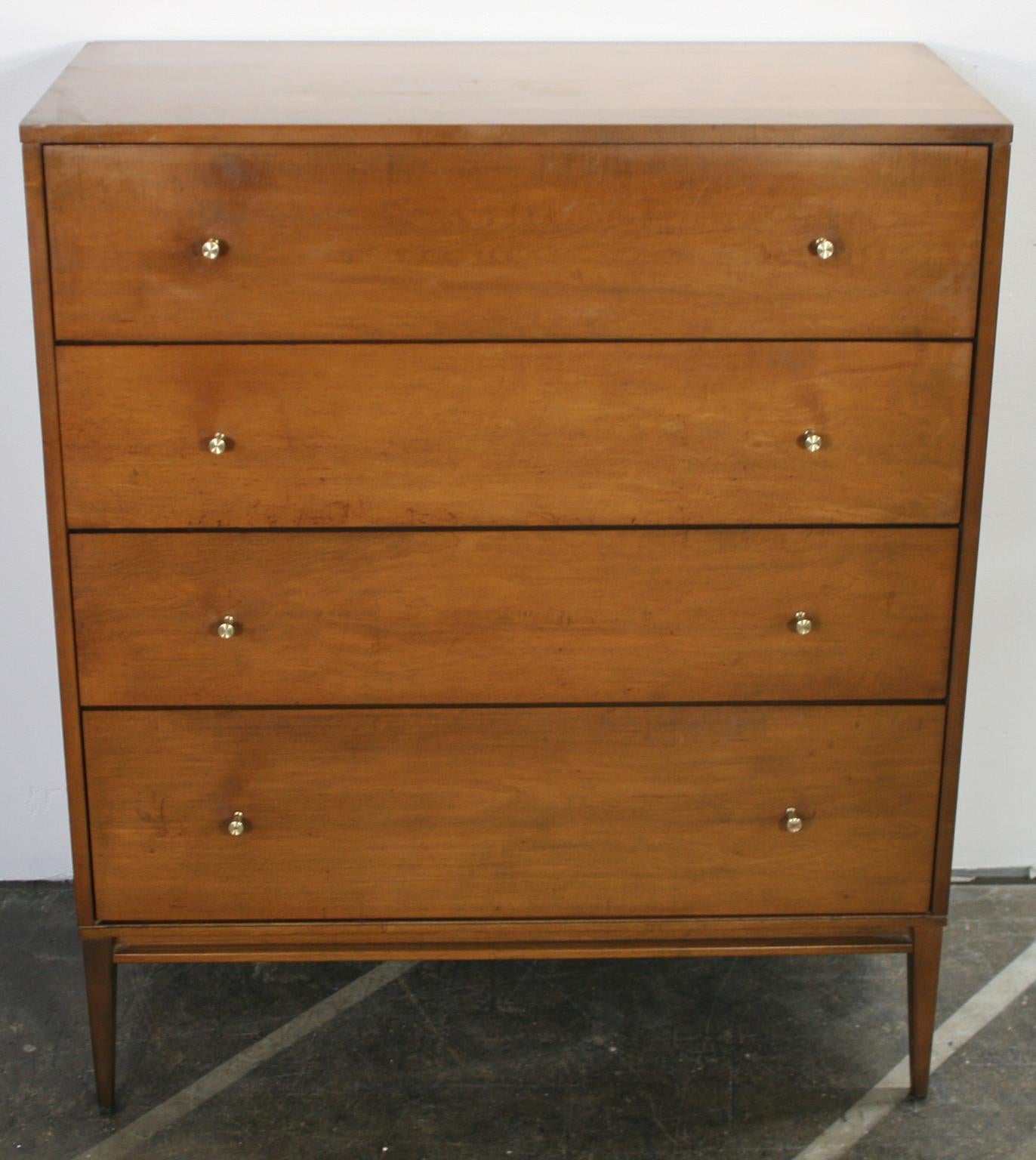 Beautiful midcentury tall dresser 4-drawer dresser by Paul McCobb circa 1950 Planner Group #1501 with 4 center drawers. Solid maple construction has a beautiful walnut stain. All original brass cone pulls polished. Sits on 4 solid maple legs with
