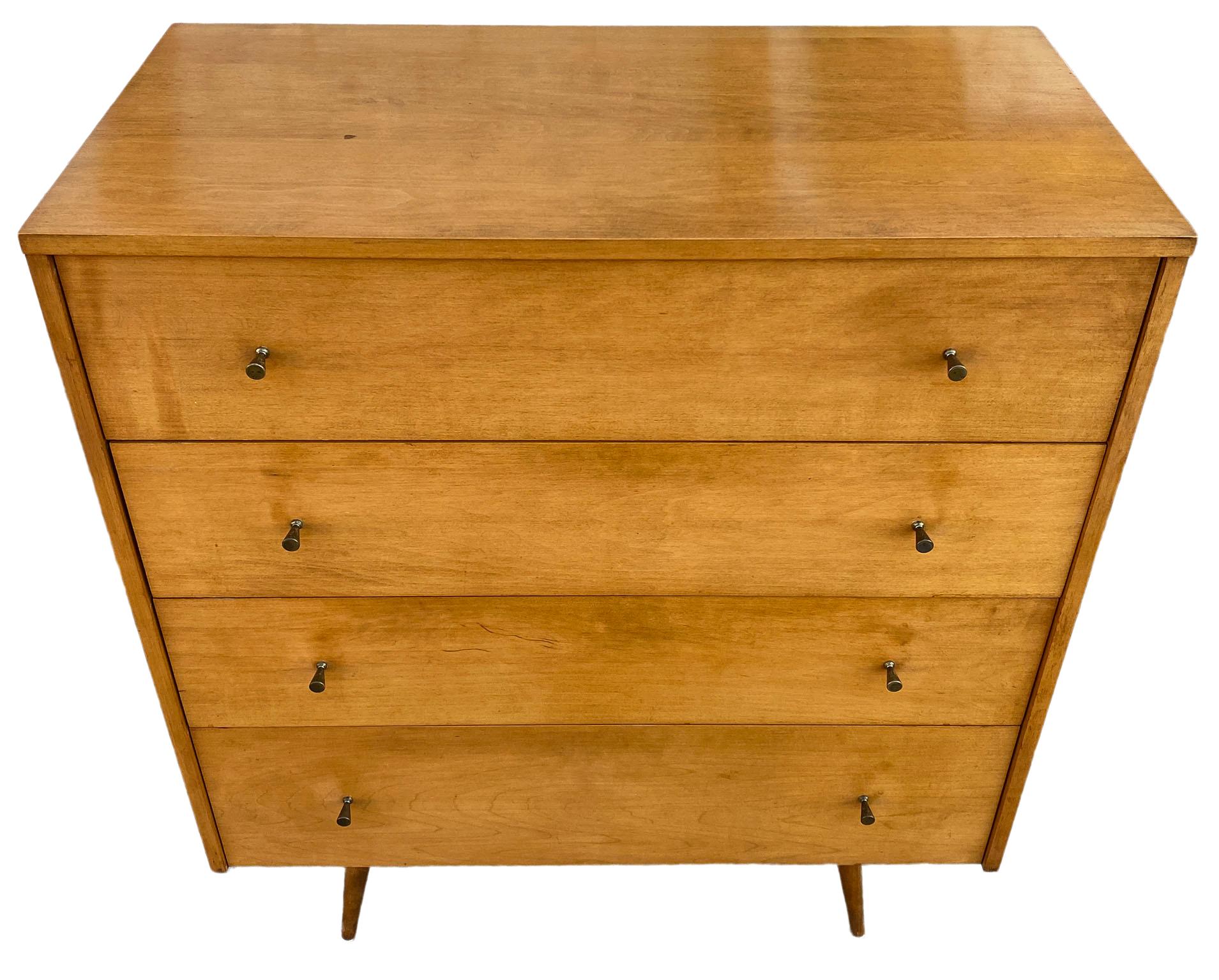 Beautiful midcentury tall dresser 4-drawer dresser by Paul McCobb circa 1950 Planner Group #1501 with 4 center drawers. Solid maple construction has a beautiful Medium Blonde original stain. All original brass cone pulls polished. Sits on 4 solid