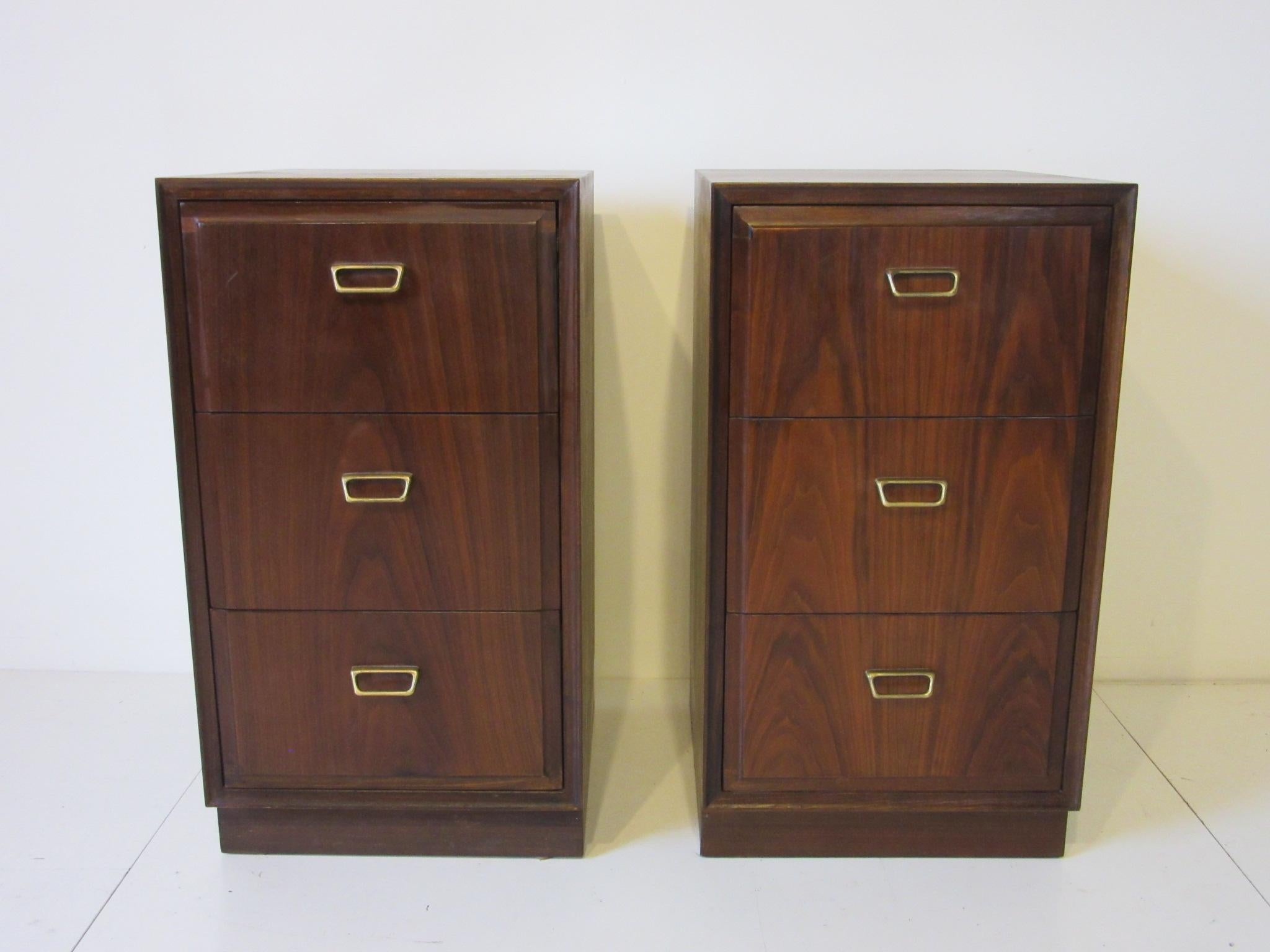 A pair of beautifully grained three drawer nightstands with brass toned pulls; these are a bit tall in design which is perfect for the new styled mattress that needs a taller profile, well constructed by the Founders Furniture Company.