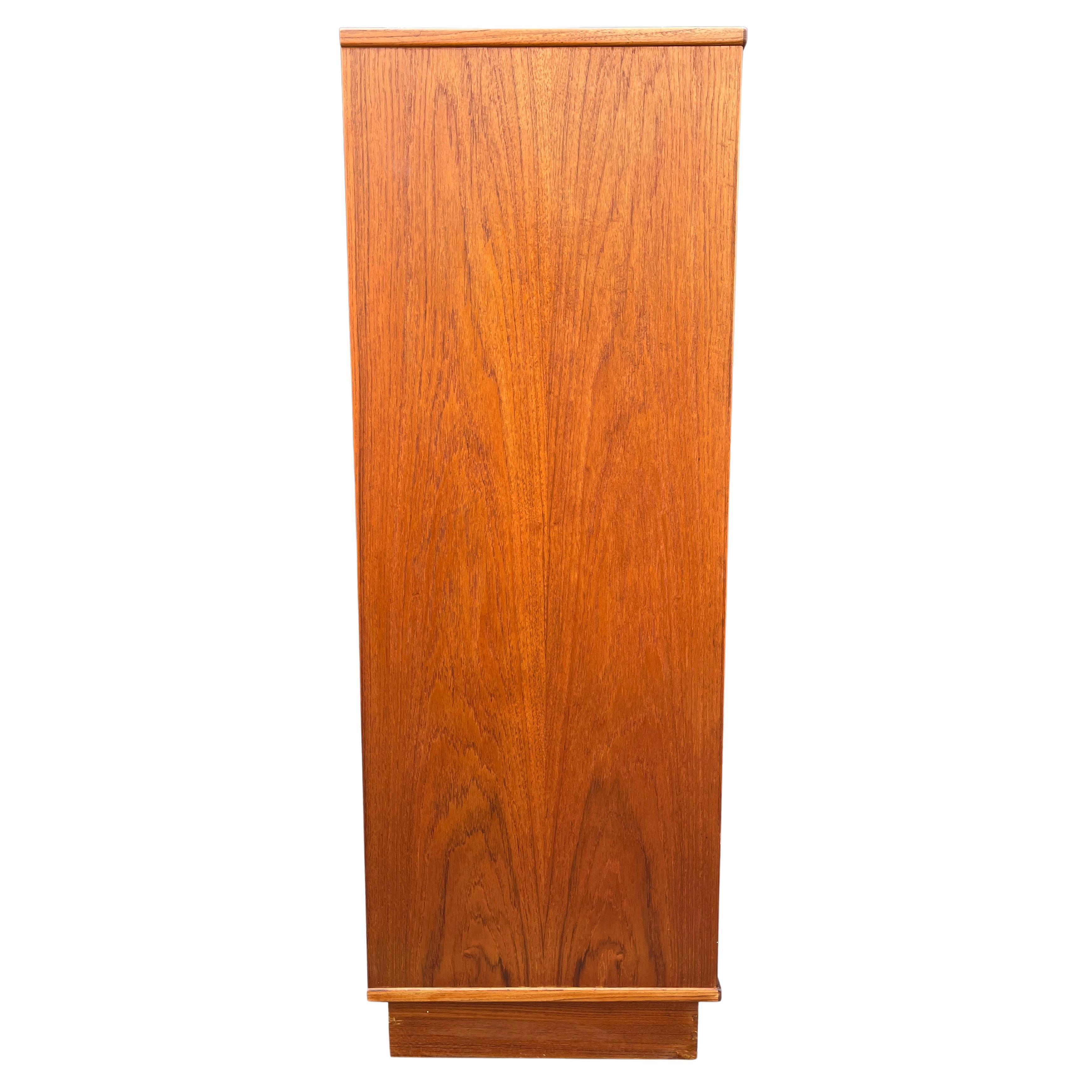 Nils Jonsson Tallboy in teak wood. 

Attractive Danish modern sleek six (6) lingerie chest of drawers circa 1970s. Designed by Nils Jonsson. This is a very simple yet modern 6 drawer design, the craftsmanship is quite striking. Features flush