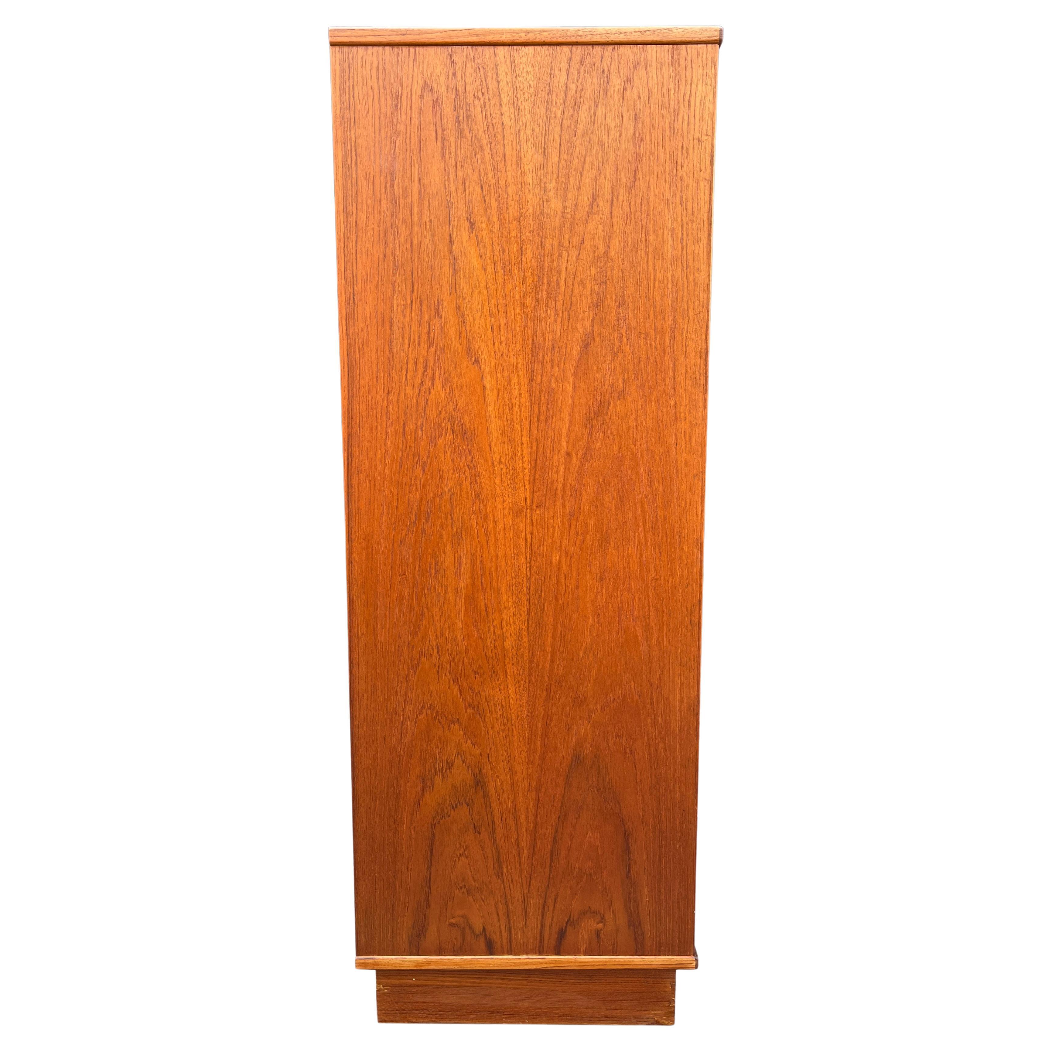 Nils Jonsson Tallboy in teak wood. 

Attractive Danish modern sleek six (6) lingerie chest of drawers circa 1970s. Designed by Nils Jonsson. This is a very simple yet modern 6 drawer design, the craftsmanship is quite striking. Features flush