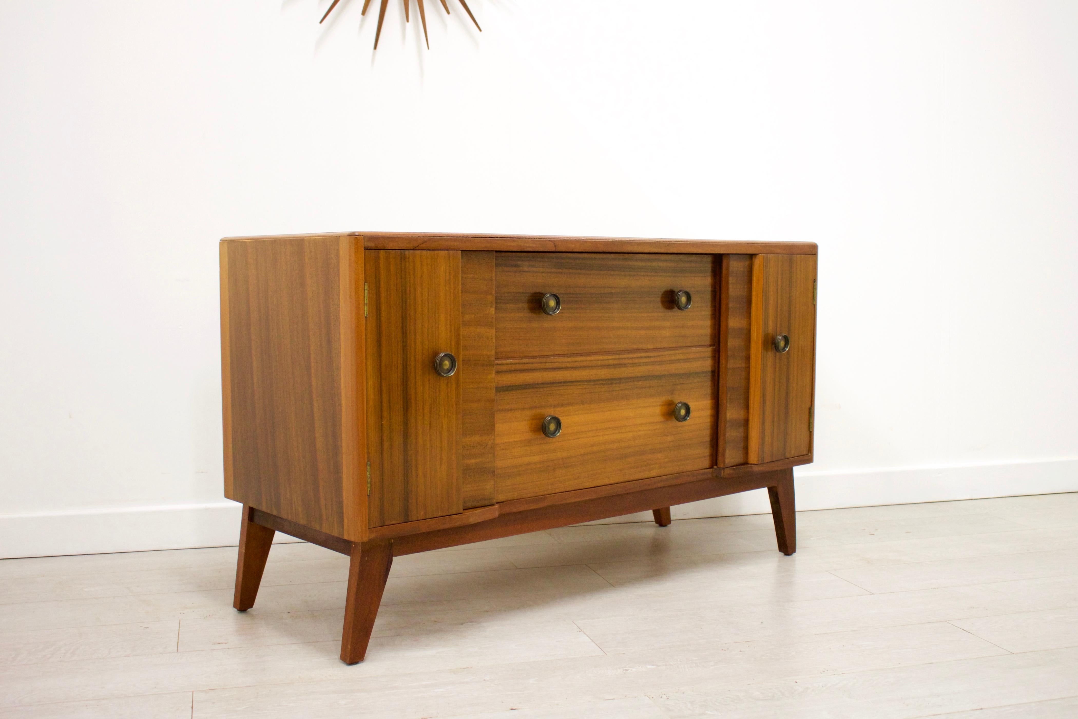- Midcentury sideboard
- Manufactured in UK
- Made from walnut and walnut veneer
- Features 2 drawers and 2 cupboards.